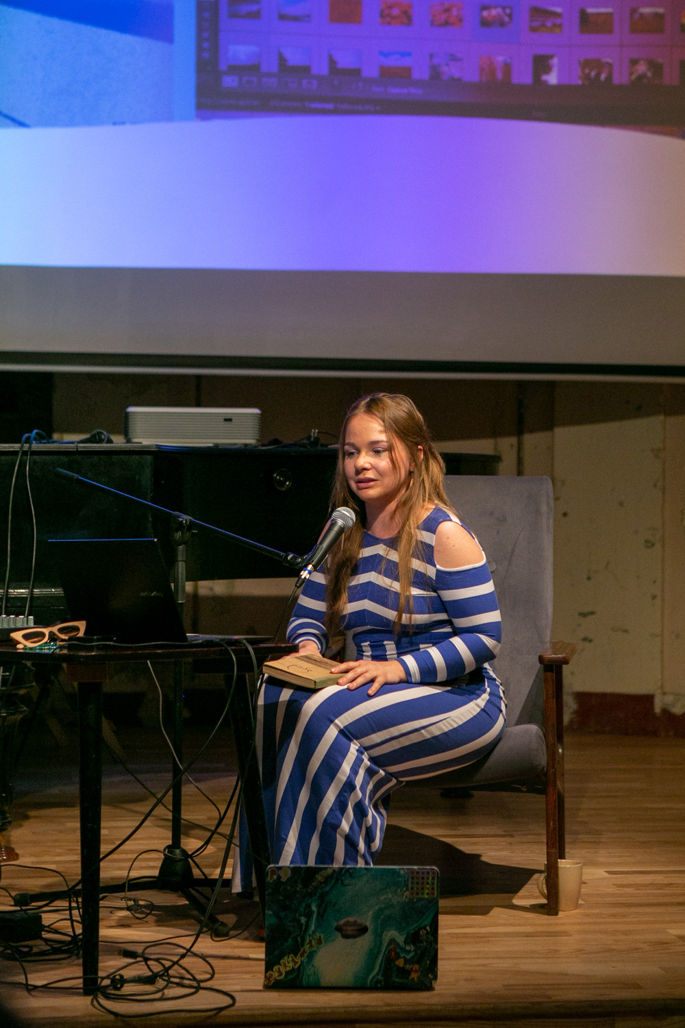 Olga Mikhalchuk is telling the audience the history of “The HARD” book. Olga Mikhalchuk, visual artist