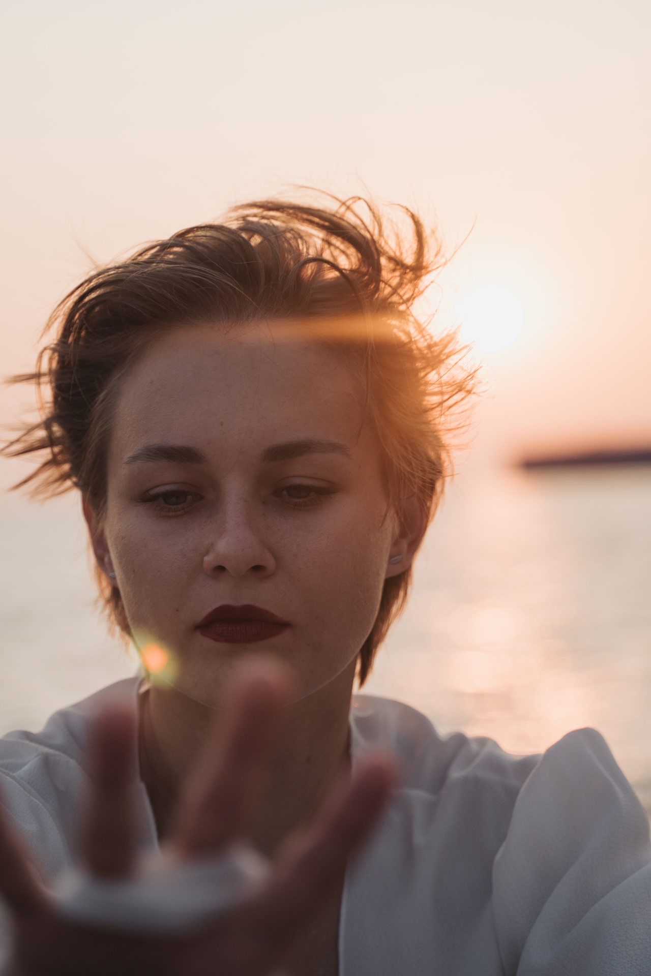 Снимок лица девушки на фоне лучей солнца
