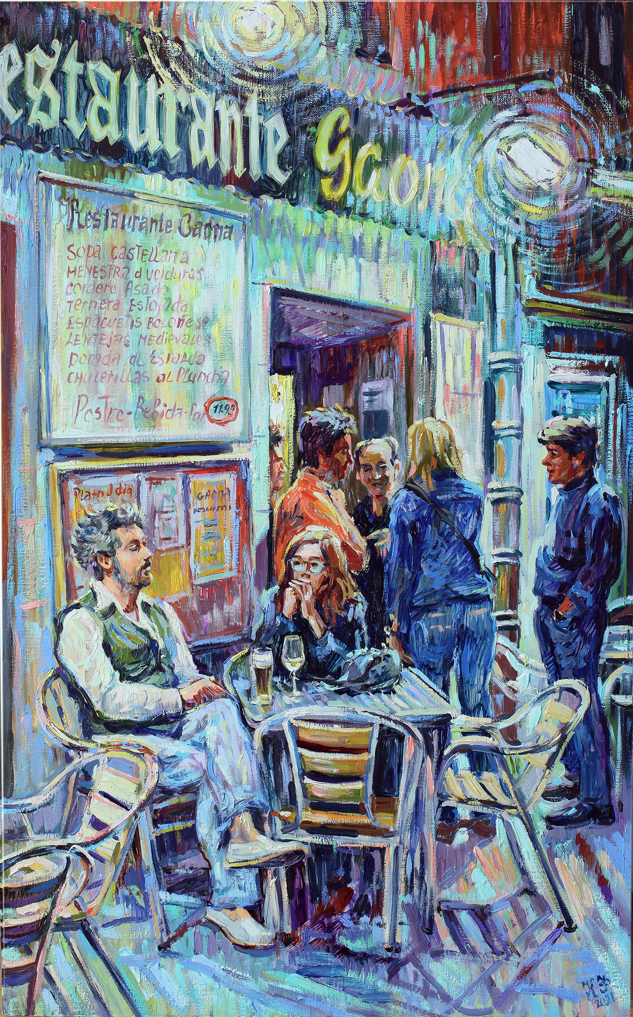A group of people at the entrance of the Gaona restaurant, a man and a woman sitting at a table with beer and wine.