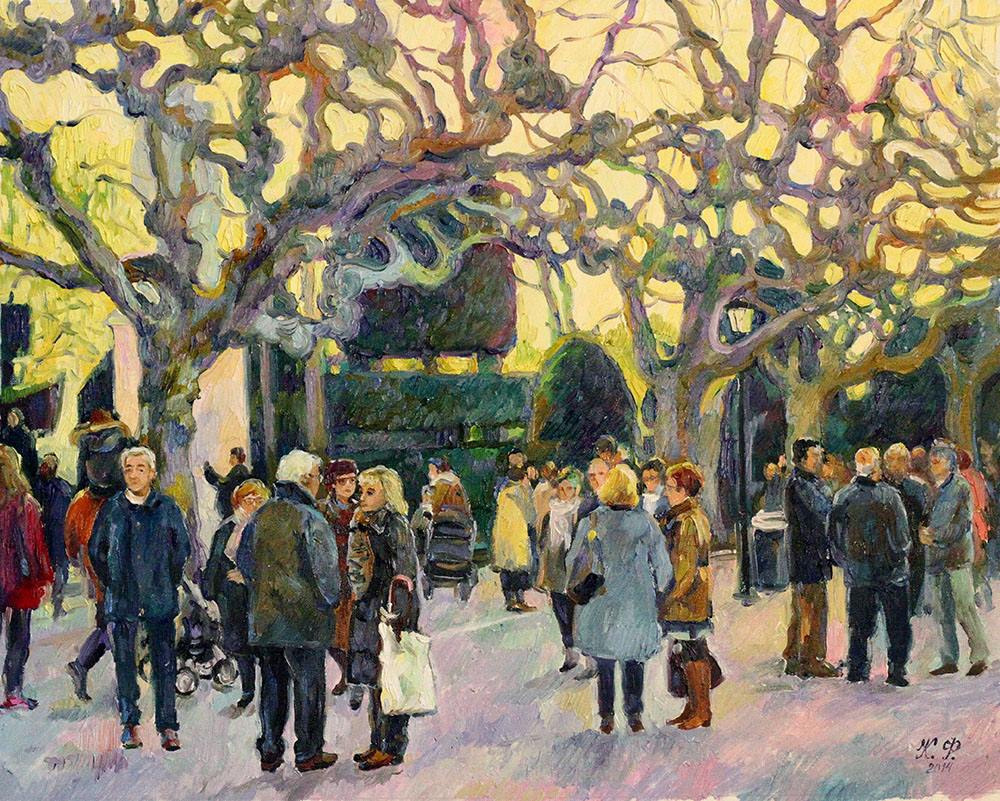 Several groups of elderly people in coats are talking to each other on Espolón Boulevard.