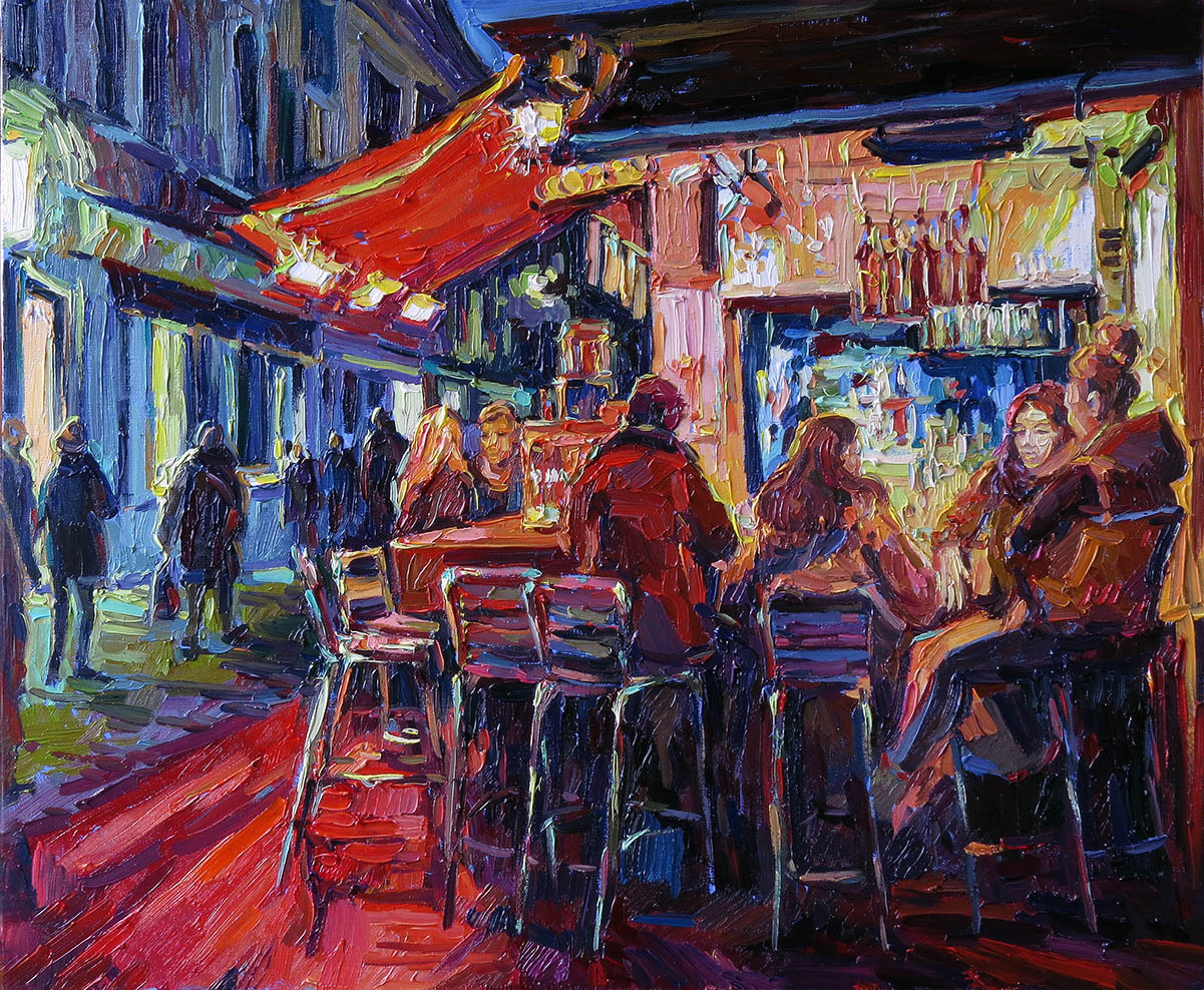 A group of people in a street bar at night
