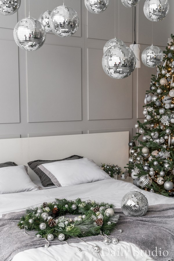 Новогодний декор спальной зоны в студии: кровать, венок, диско-шар