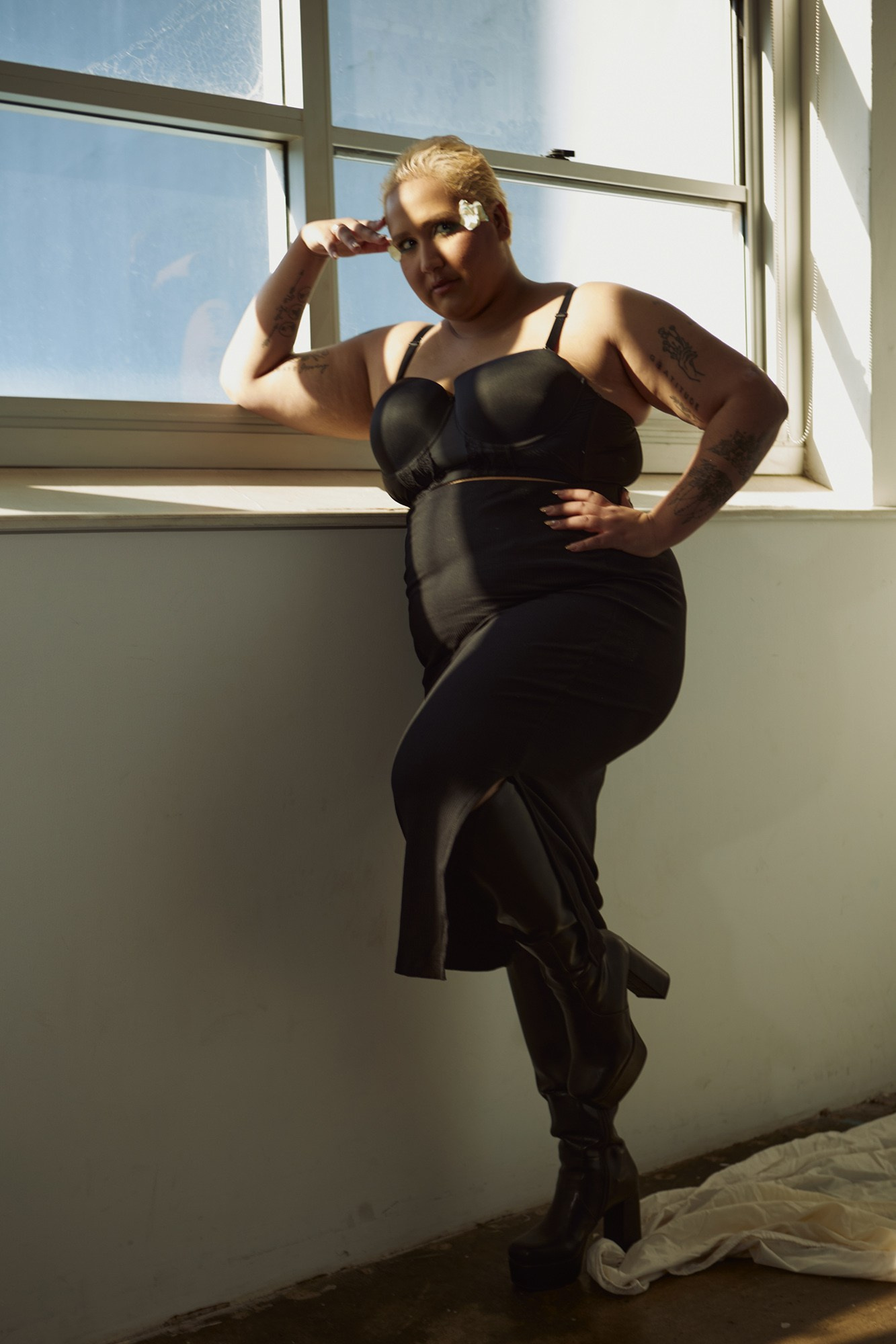 Fashion portrait of model Doriane Cannon in a black dress by a window during a Sydney portfolio photoshoot.