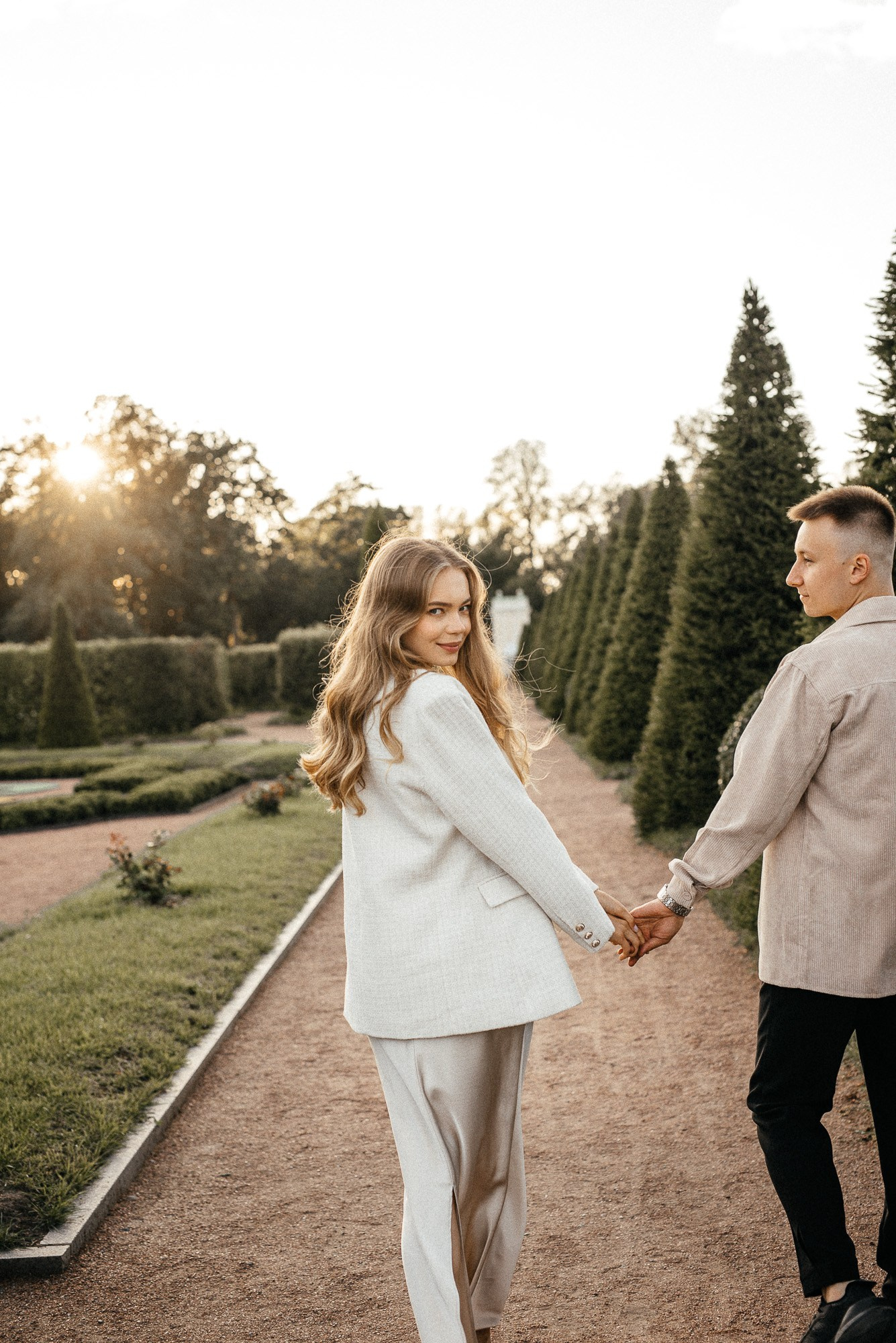 Пара прогуливается по парку в Ораниенбауме во время фотосессии love story