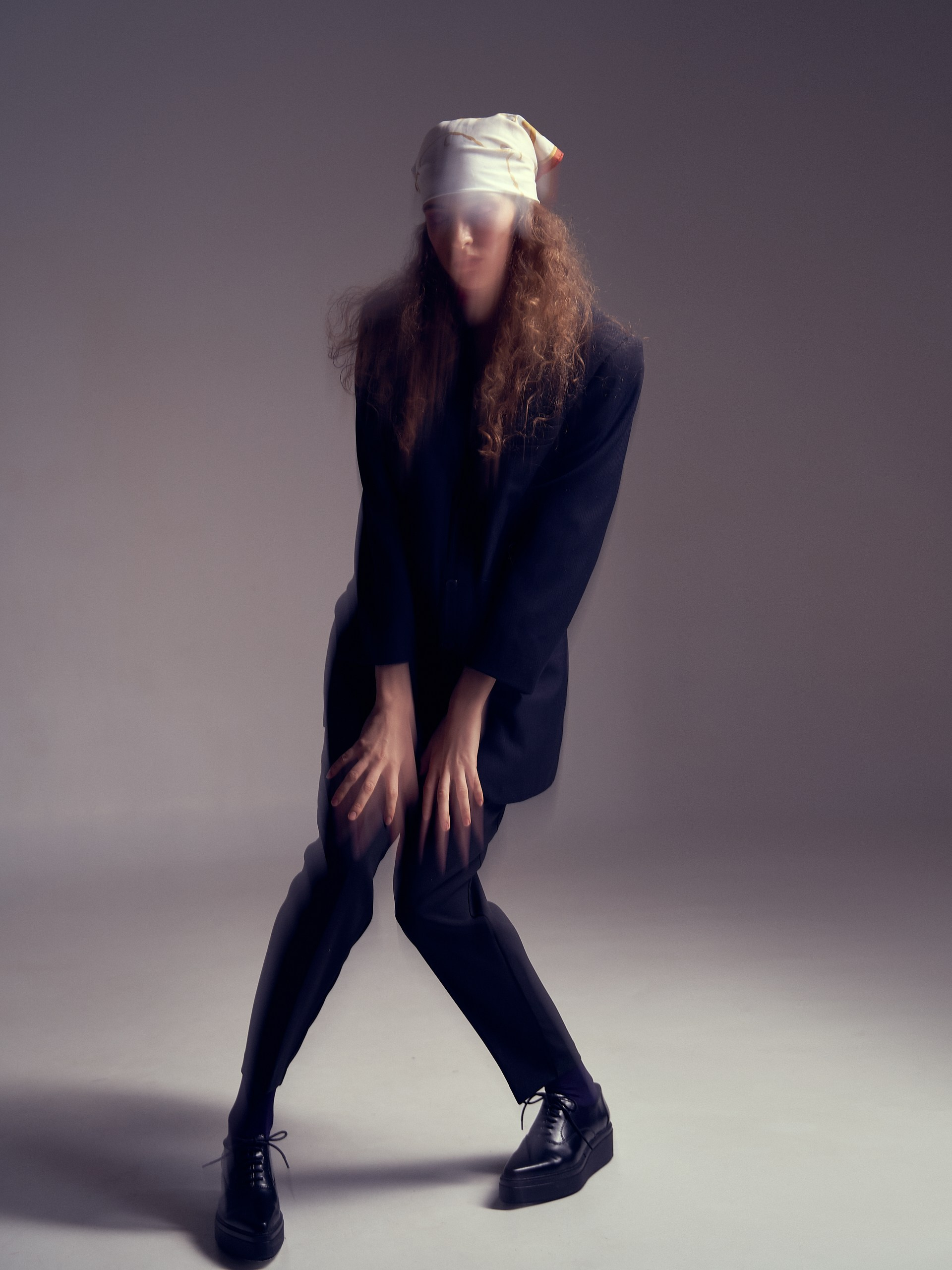 Каталожная фотосессия женского образа в тёмной одежде и белой панаме, минималистичный фон