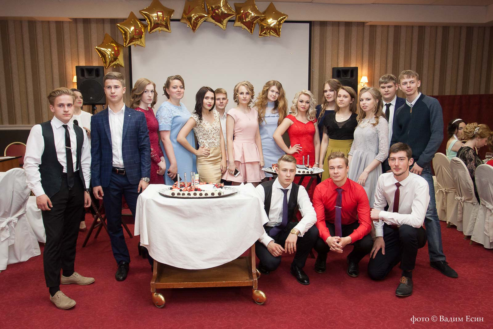 Групповая фотография 11 класса в зале с красным ковром.