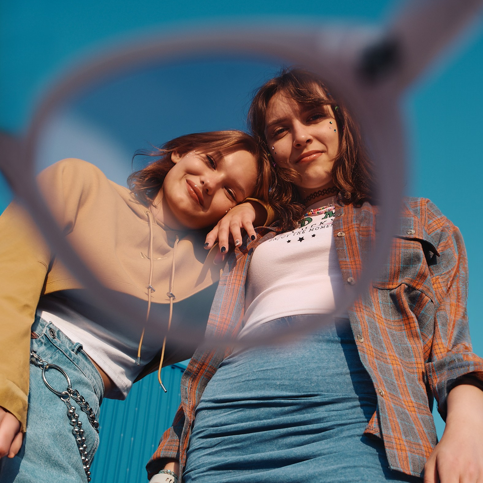 Две молодые девушки рядом сняты через стекло розовых очков