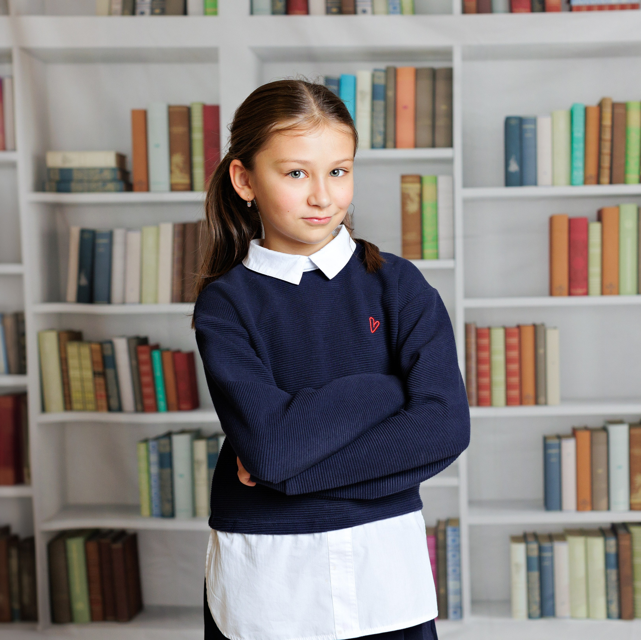 Мальчик в парадной кадетской форме на однотонном студийном фоне.