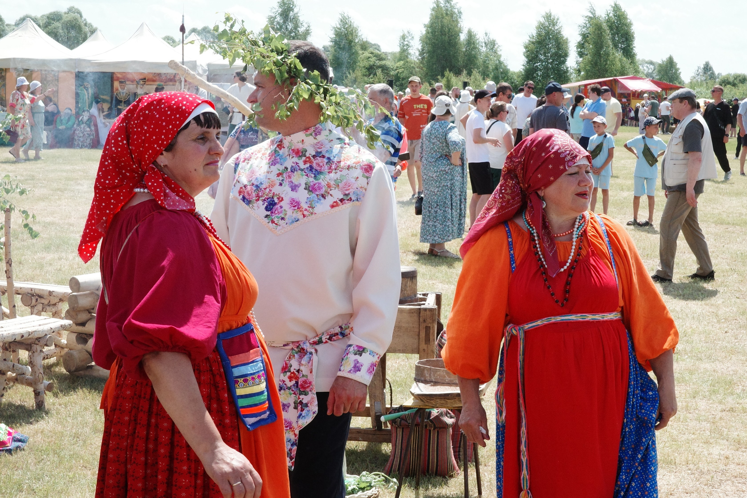 Мужчина и две женщины в традиционных мордовских костюмах, венок из берёзы на голове мужчины