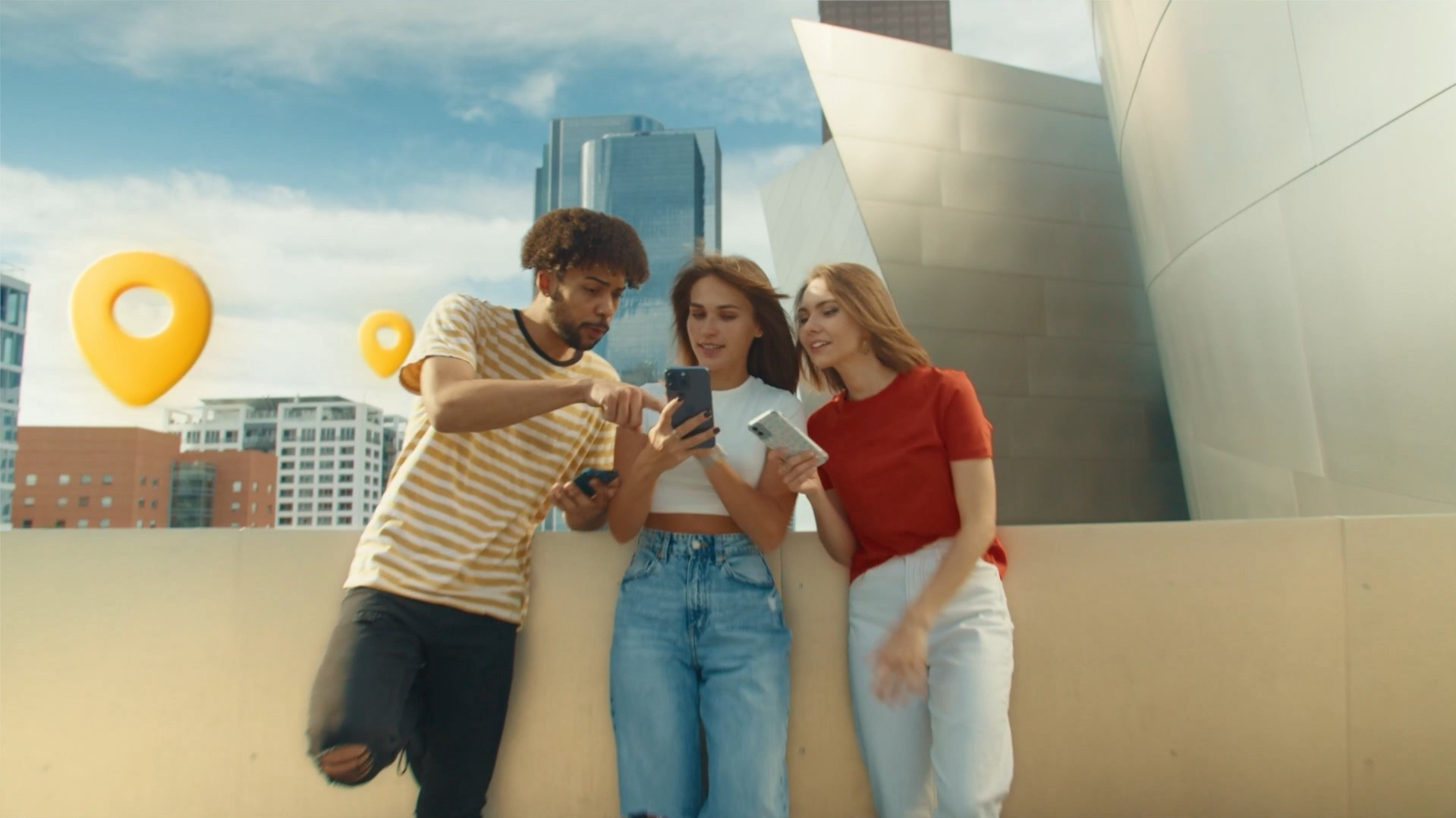 Group of friends looking at a phone near Walt Disney Concert Hall, with floating location markers in the background.
