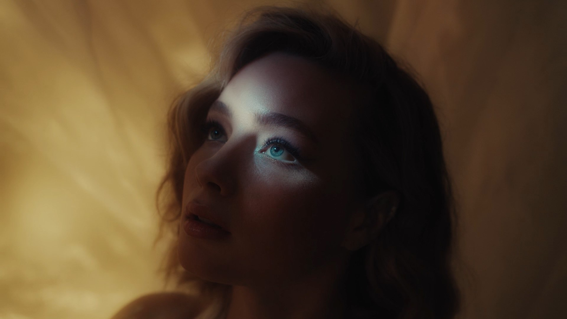 Dreamy portrait of a model with golden light, creating an artistic and ethereal mood.