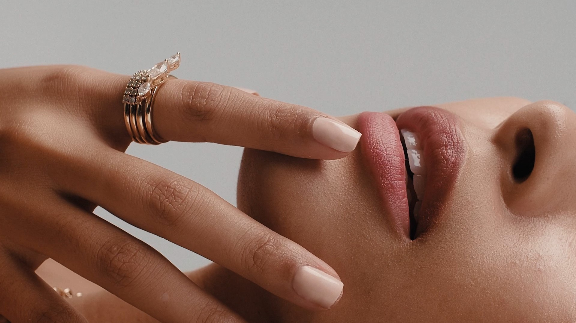 Close-up of lips and rings, showcasing intricate design and premium craftsmanship.