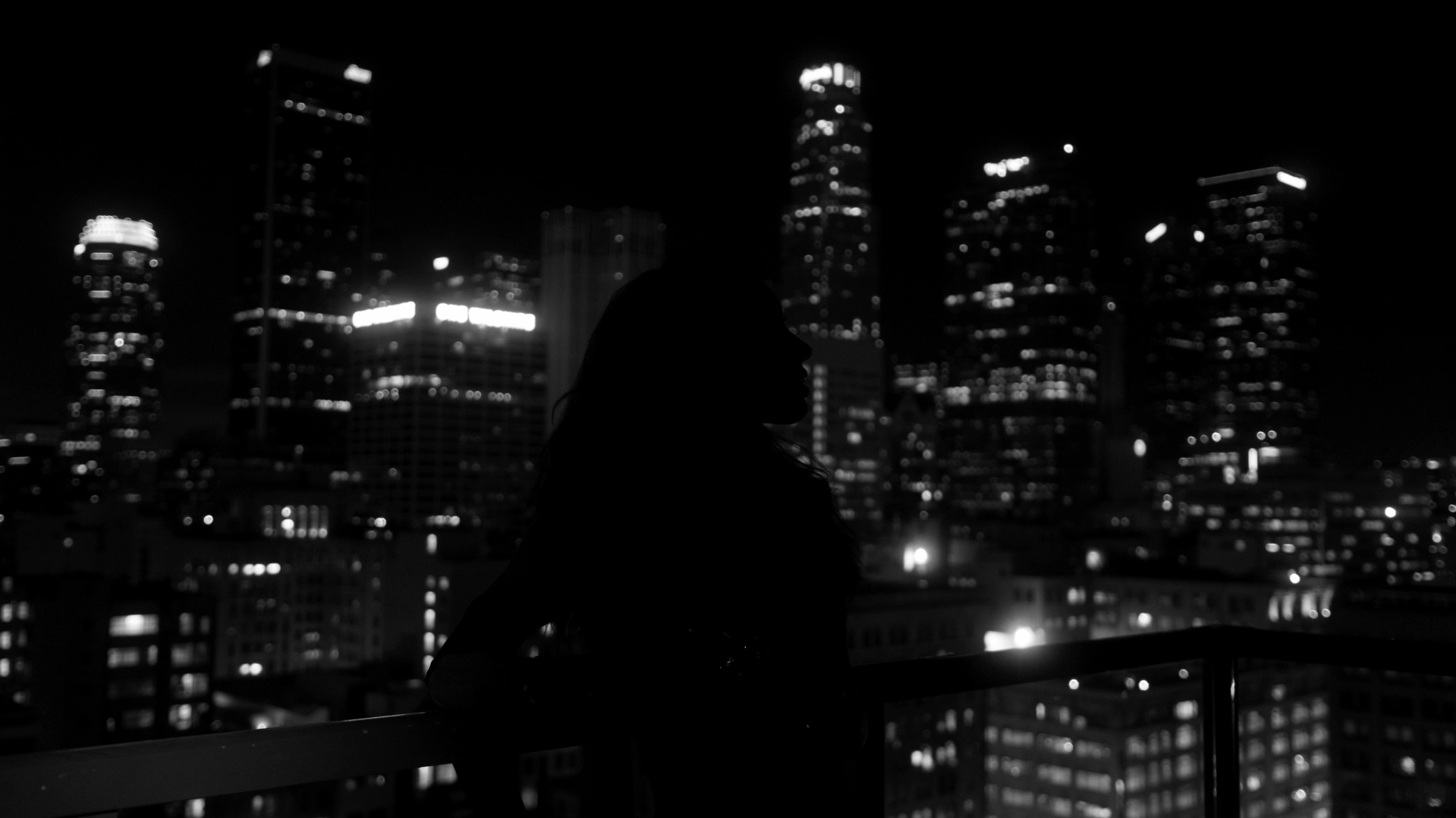 Nighttime view of Los Angeles with sparkling city lights illuminating the skyline, capturing the vibrant energy of the city that never sleeps.