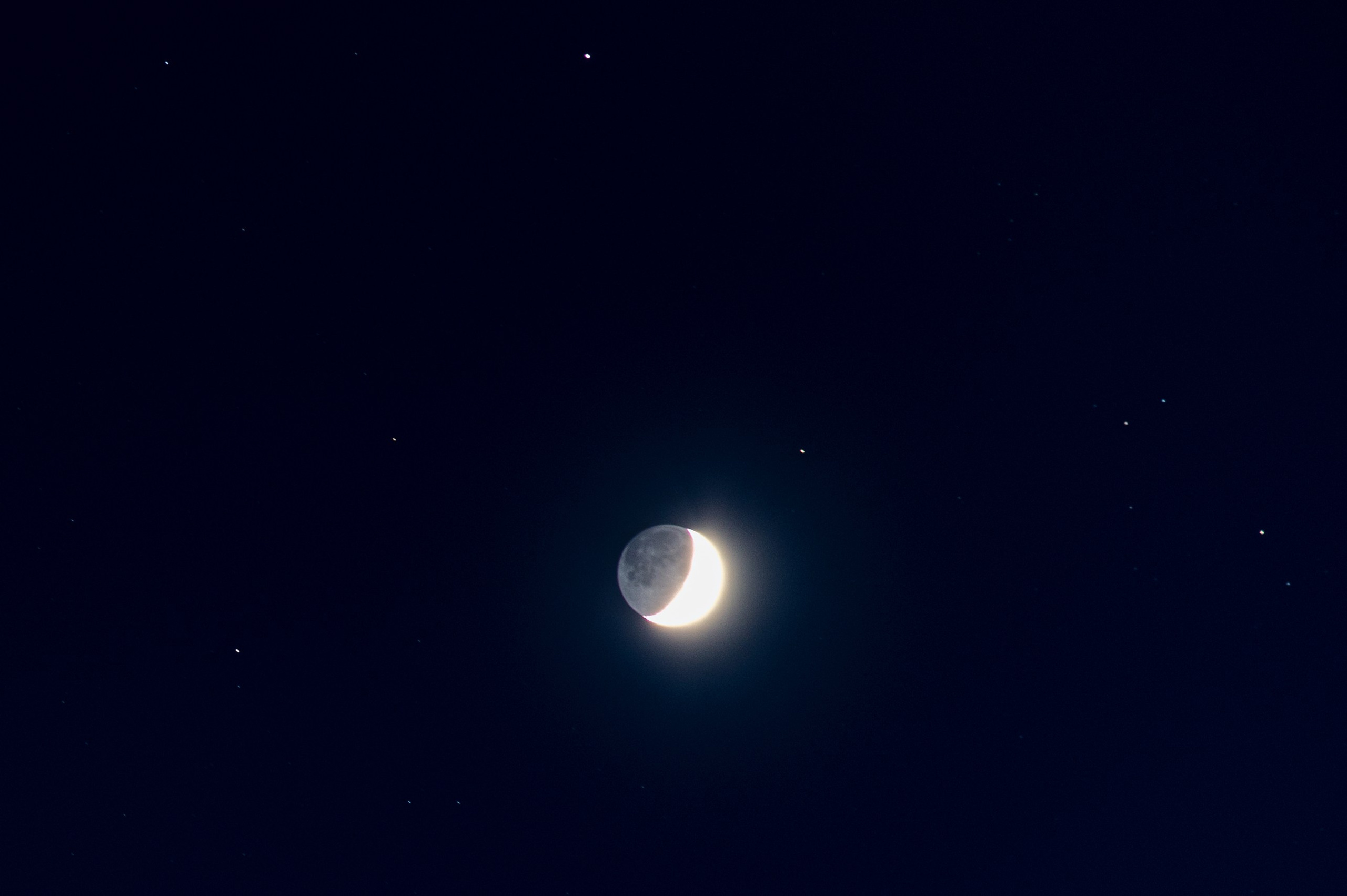 Moon and stars in a beautiful deep blue sky