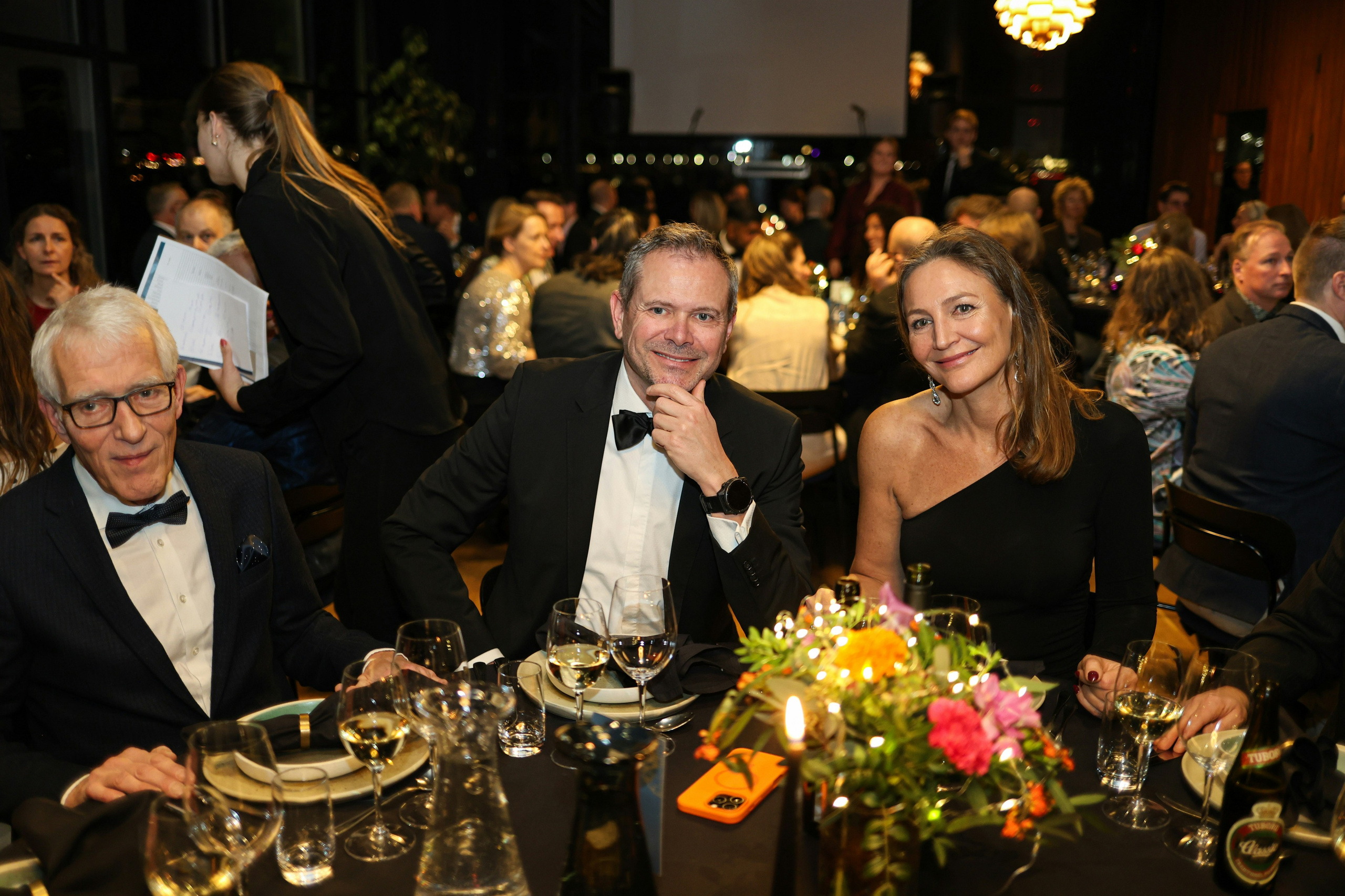 Private dinner gathering with guests in formal attire