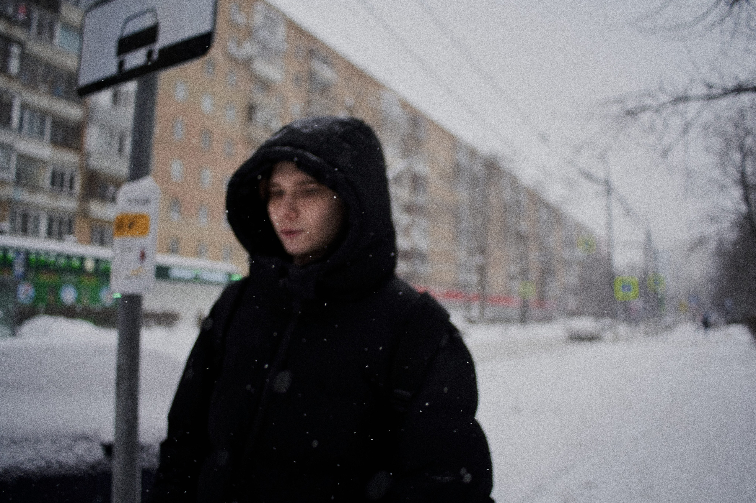 Woman in a fur coat during snowfall. Young woman wearing a fur coat walking along a snowy street in Moscow.