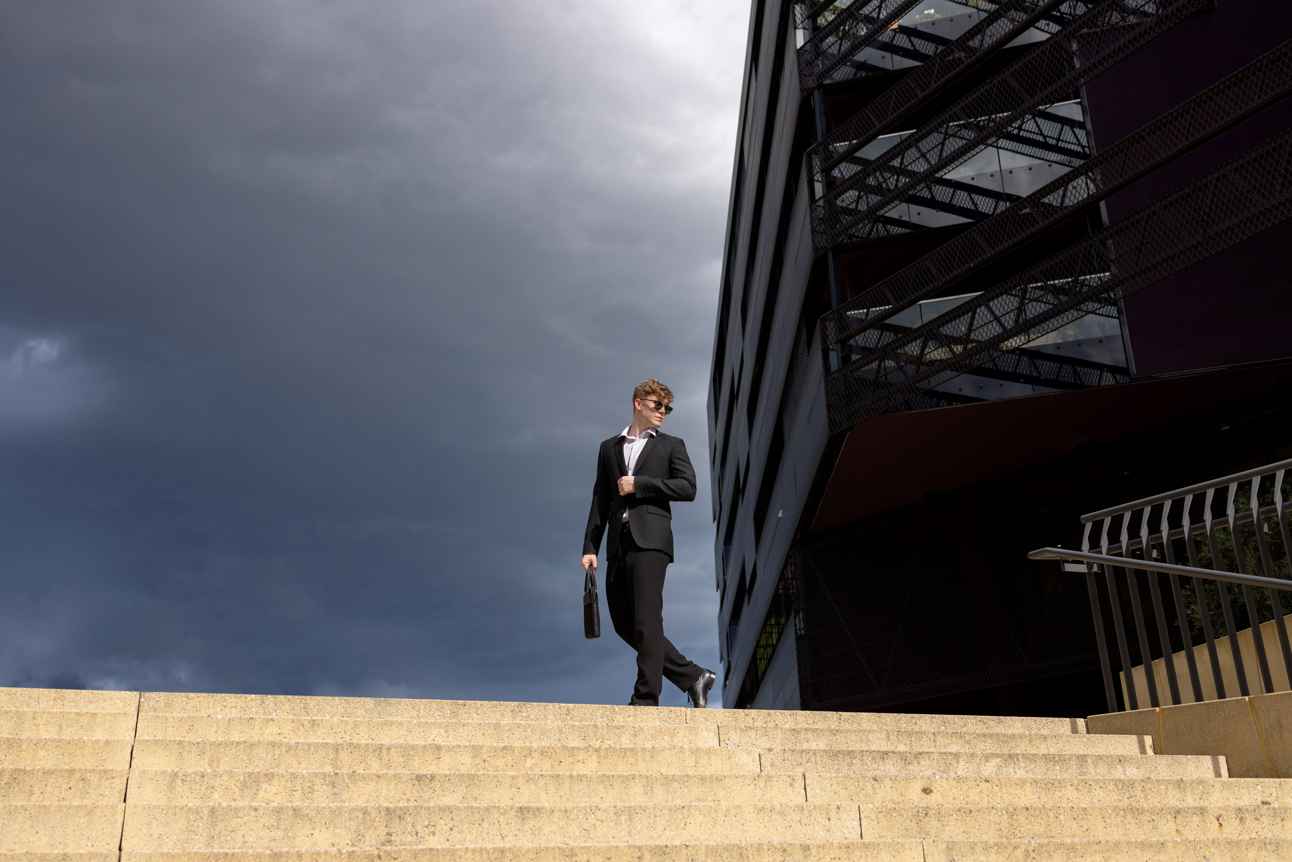Men's photo shoot on the street: businessman in the city, monochrome