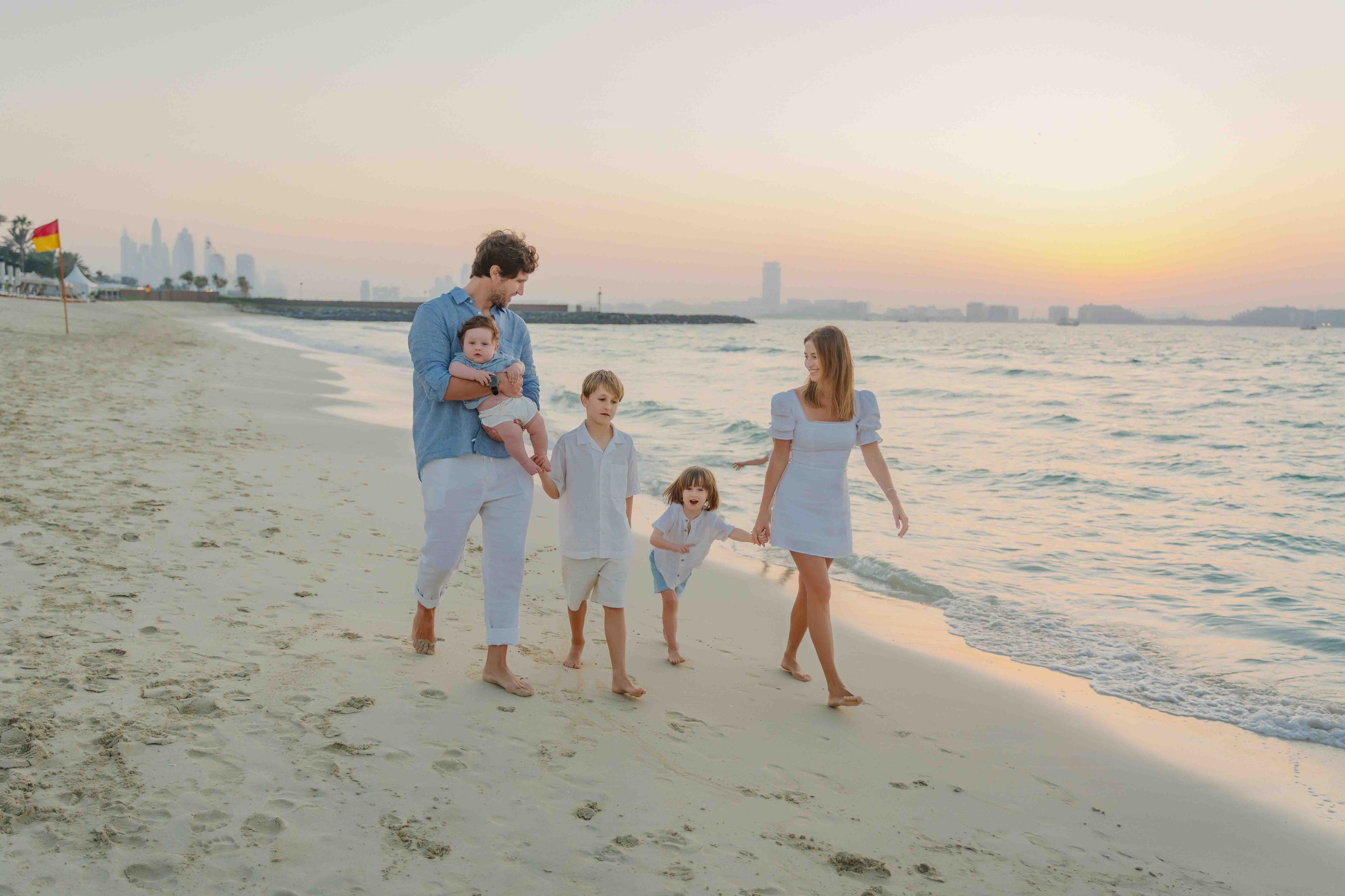 Couple walking on&nbsp;desert dunes near Abu Dhabi at&nbsp;golden hour