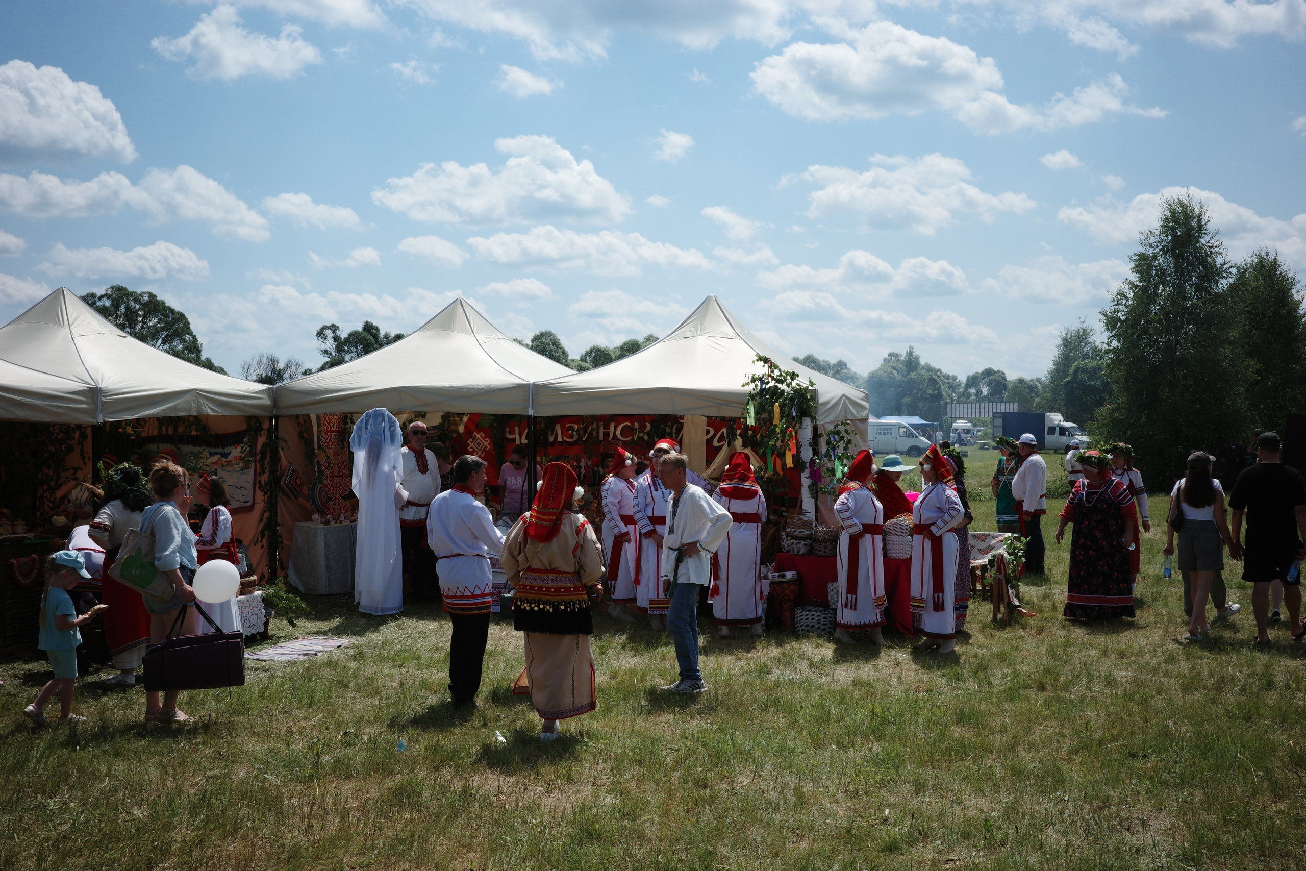 Группа людей в мордовских народных костюмах у шатра с флагом