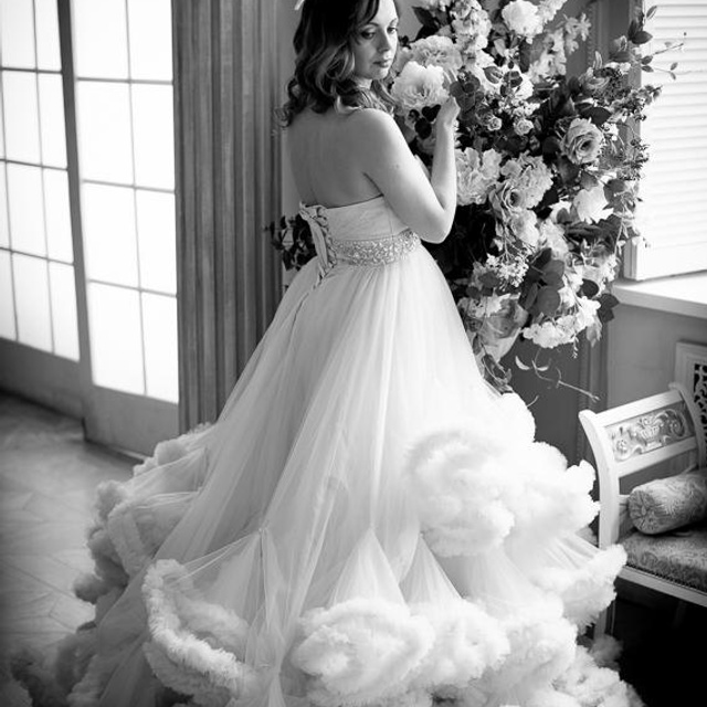 Фотосъемка красивой беременной девушки в персиковом платье-облаке в фото студии Мимика на фото большого букета цветов