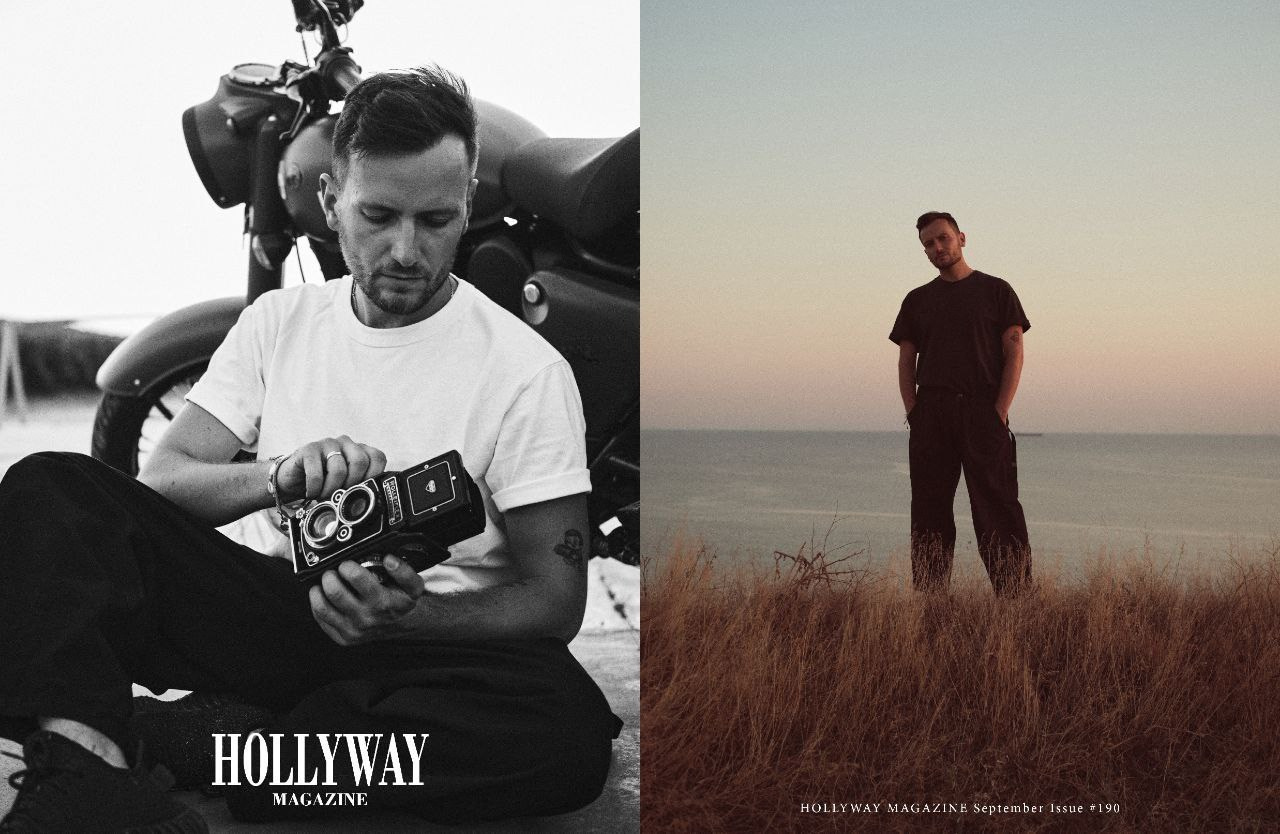 Мужчина возле мотоцикла с фотоаппаратом в руках и мужчина на берегу моря