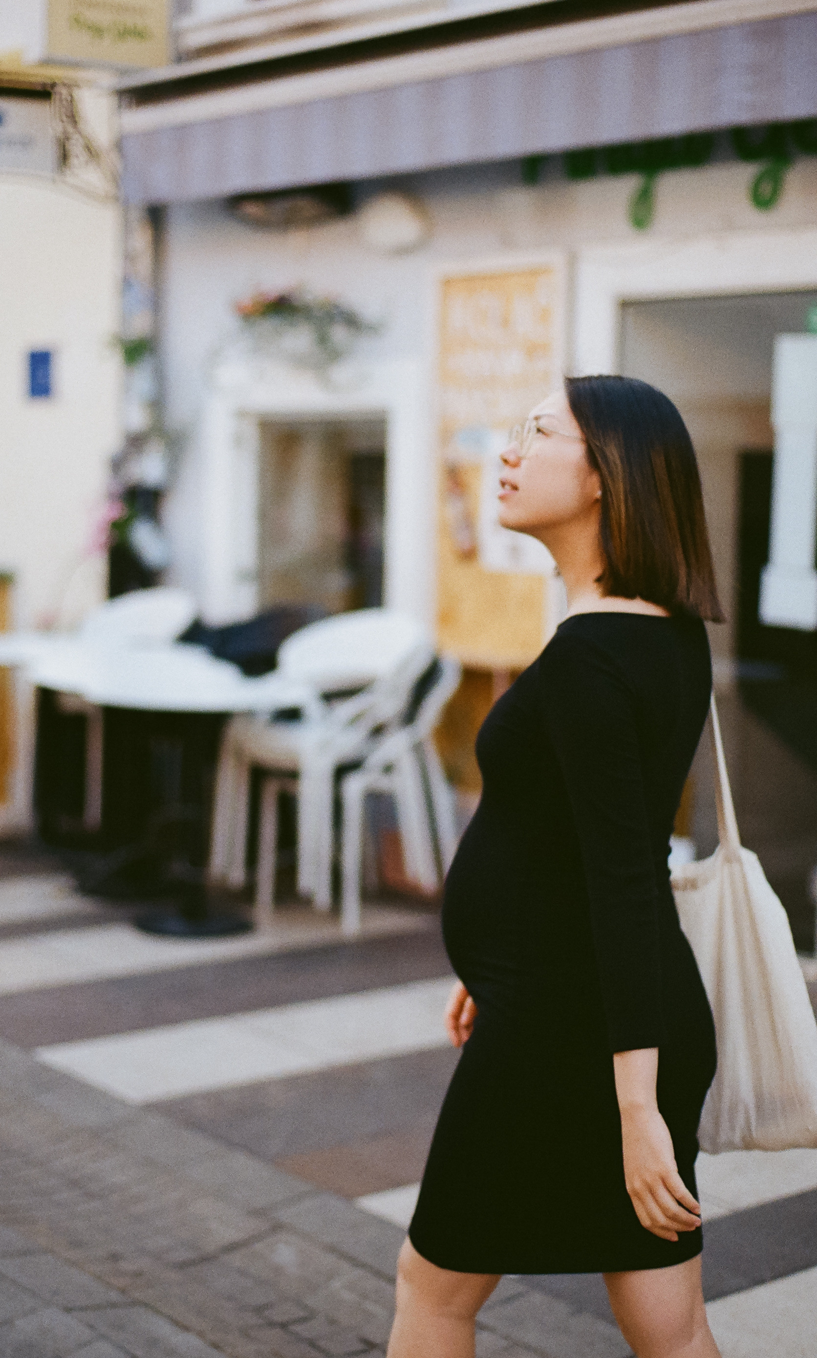 a pregnant girl strolling the city