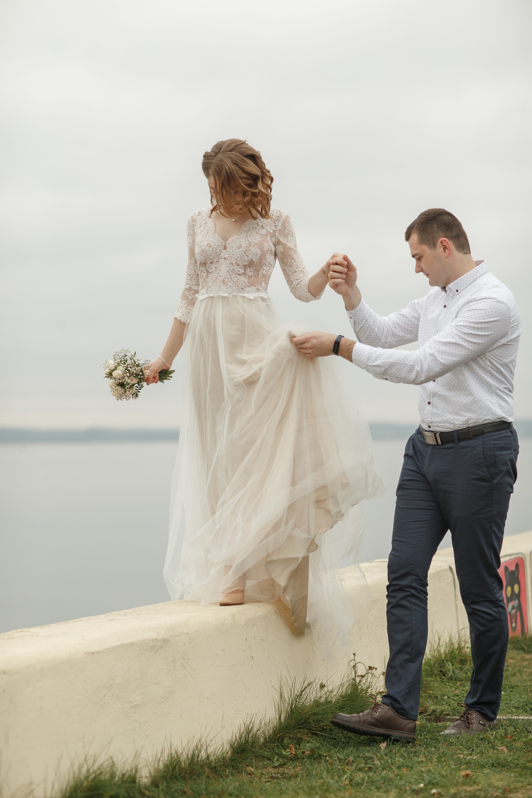 Свадебная прогулка красивой пары на берегу озера