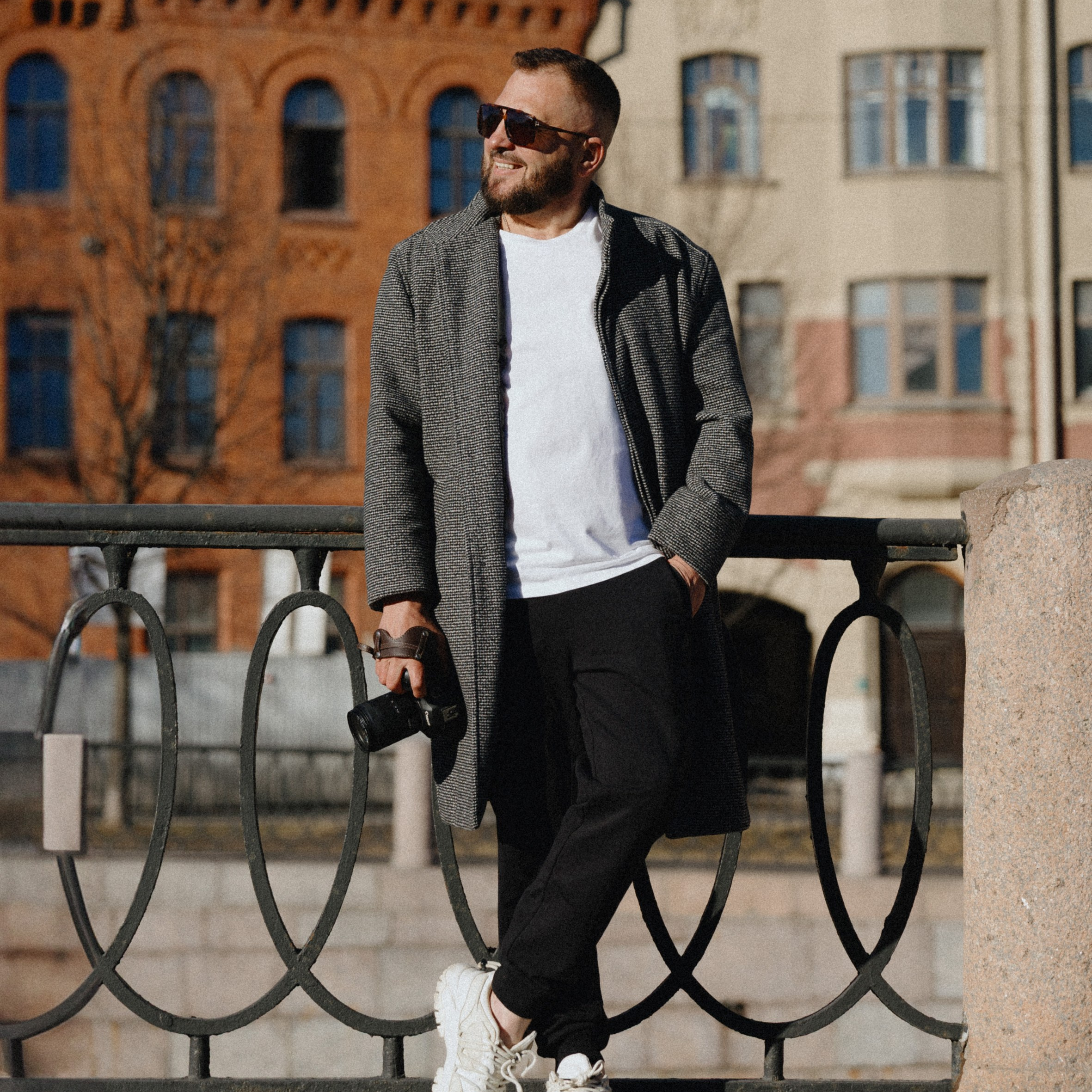 Свадебный фотограф в СПБ Сергей Слесарчук с камерой на фоне архитектуры Санкт-Петербурга.