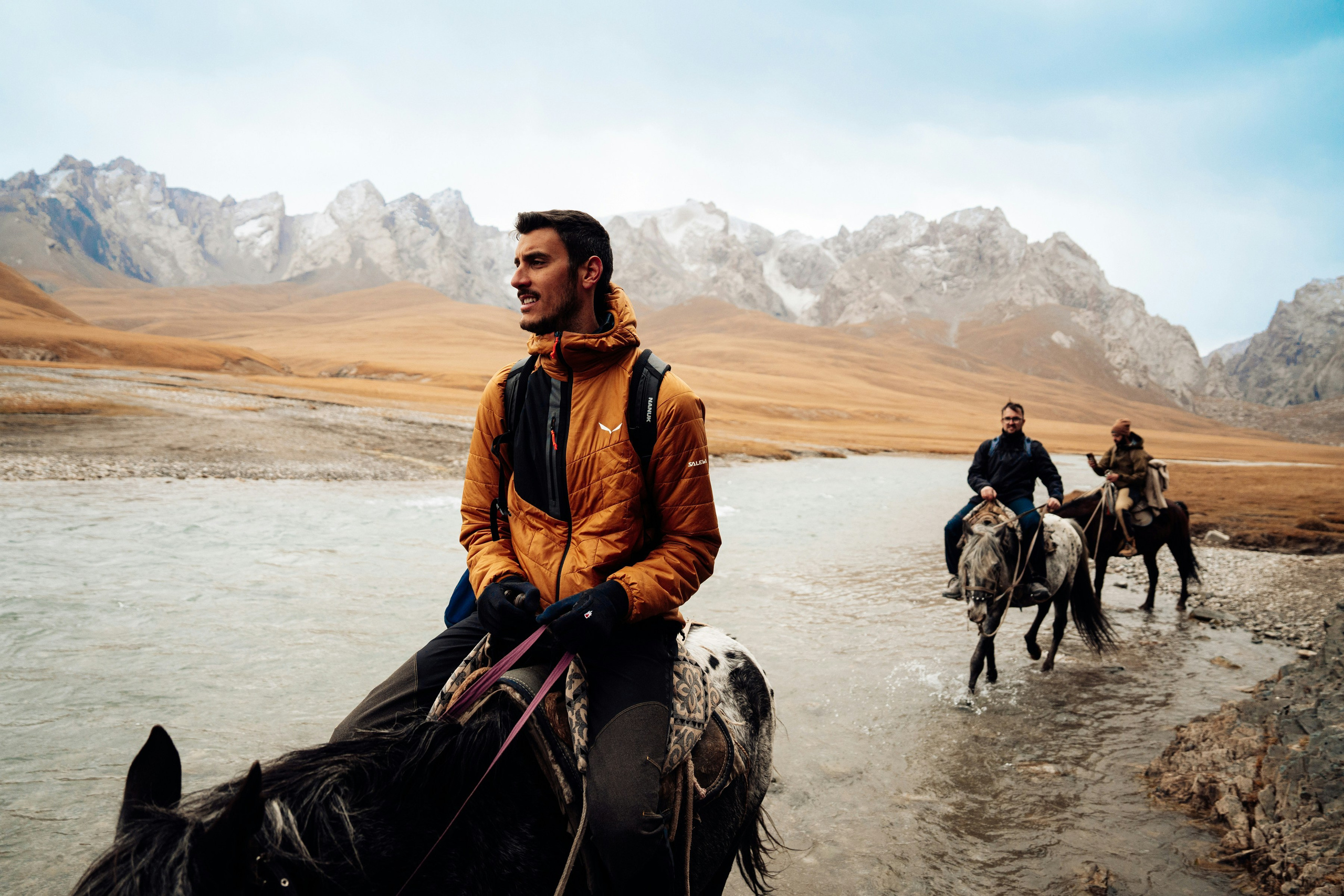Expedition photography tour on horseback in a remote mountain landscape