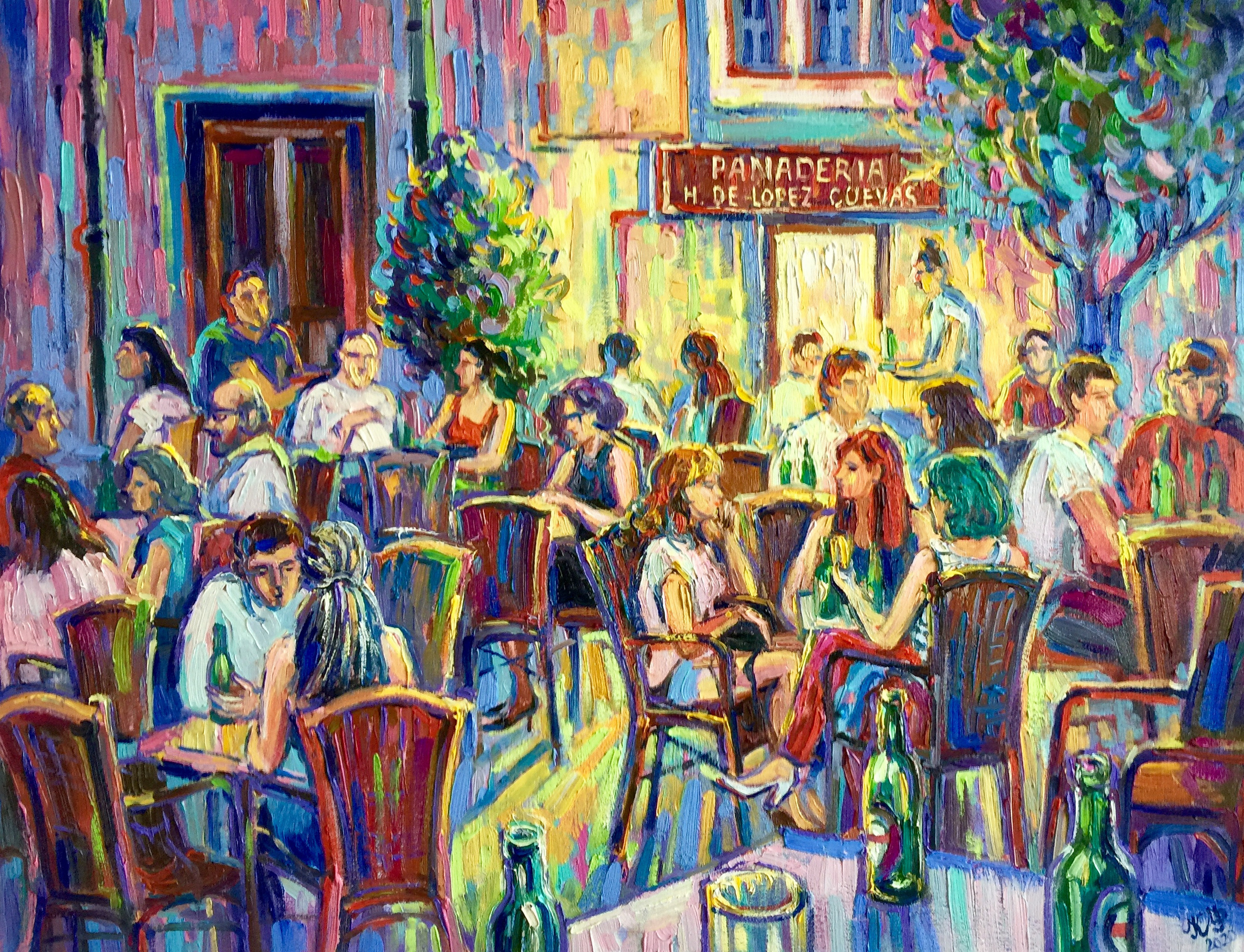 Several groups of friends drinking beer on the terrace in front of the Lopez Cuevas bakery.