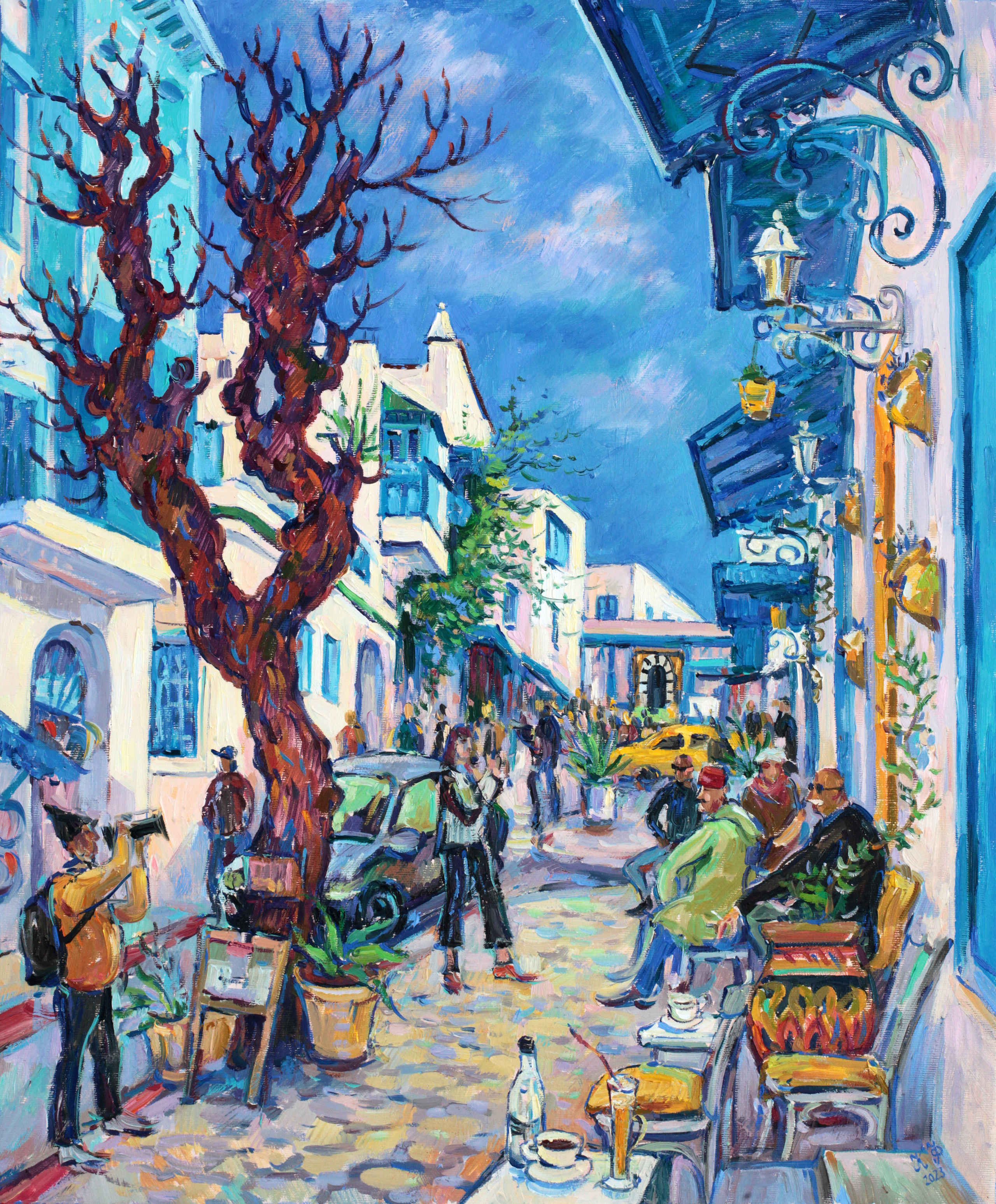 Street on the slope of Sidi bou Said: men in a cafe and a tourist with a camera