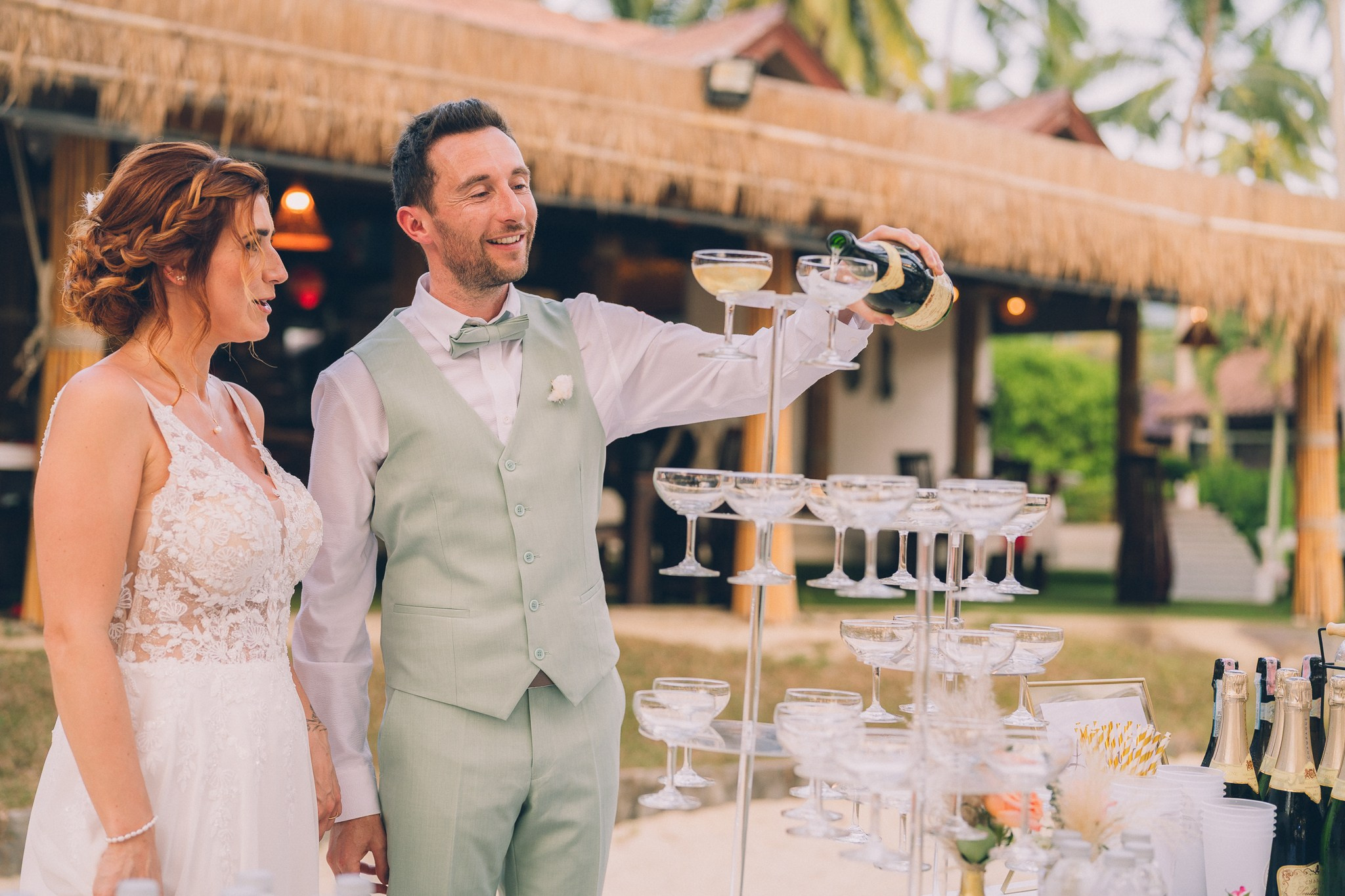 Wedding celebration with guests on a tropical sunset beach in Koh Samui