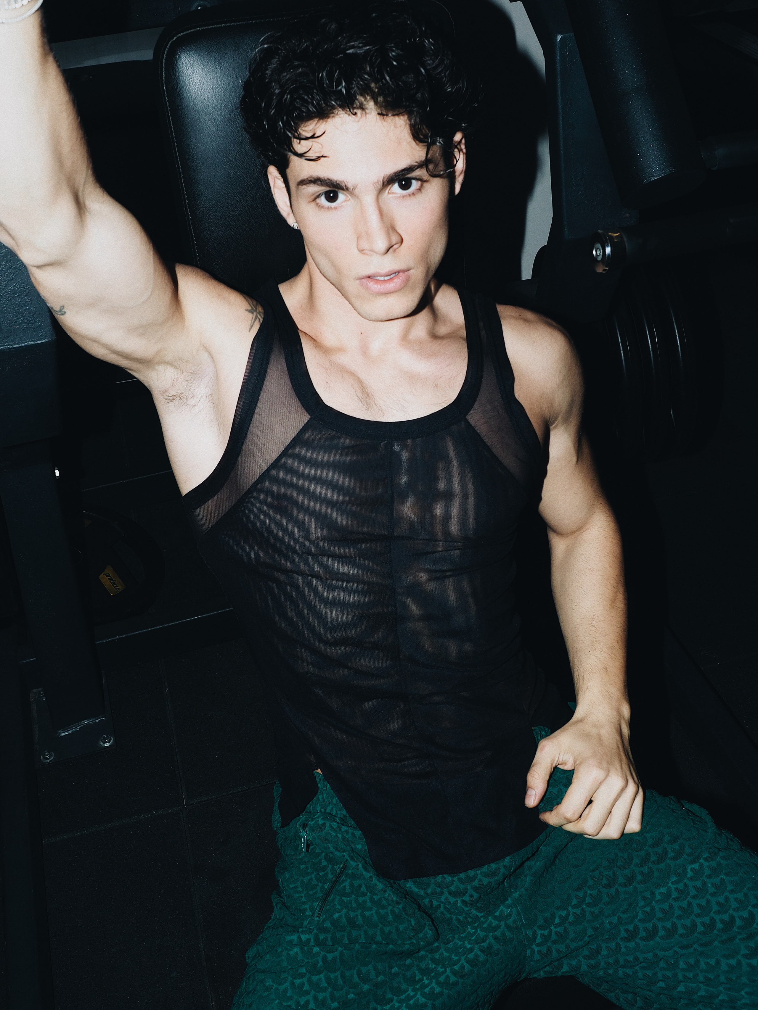 Men’s fashion editorial photoshoot with sheer top and dramatic lighting, contemporary fashion photography, Sergio Maiis