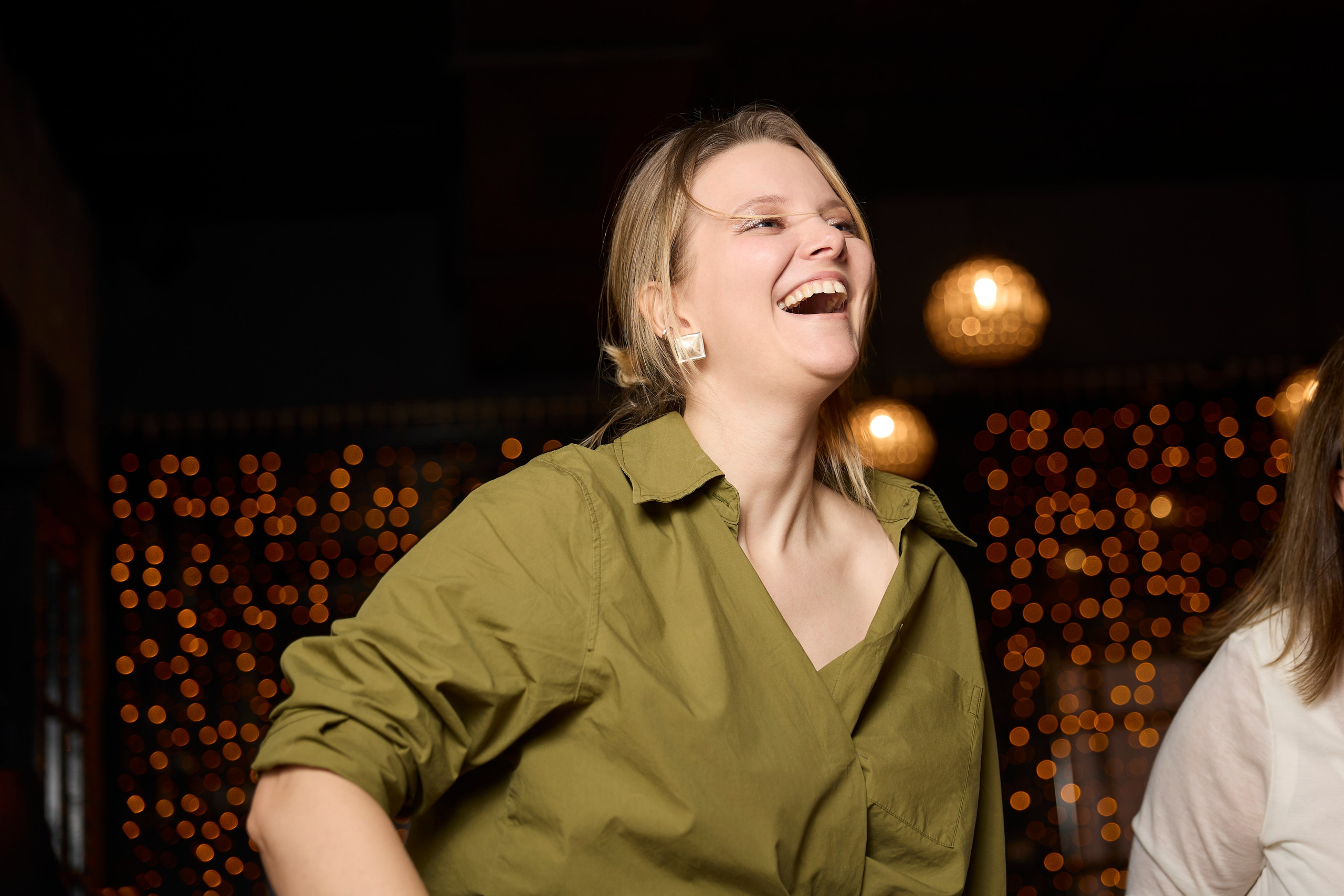 Смеющаяся девушка на мероприятии в ресторане.