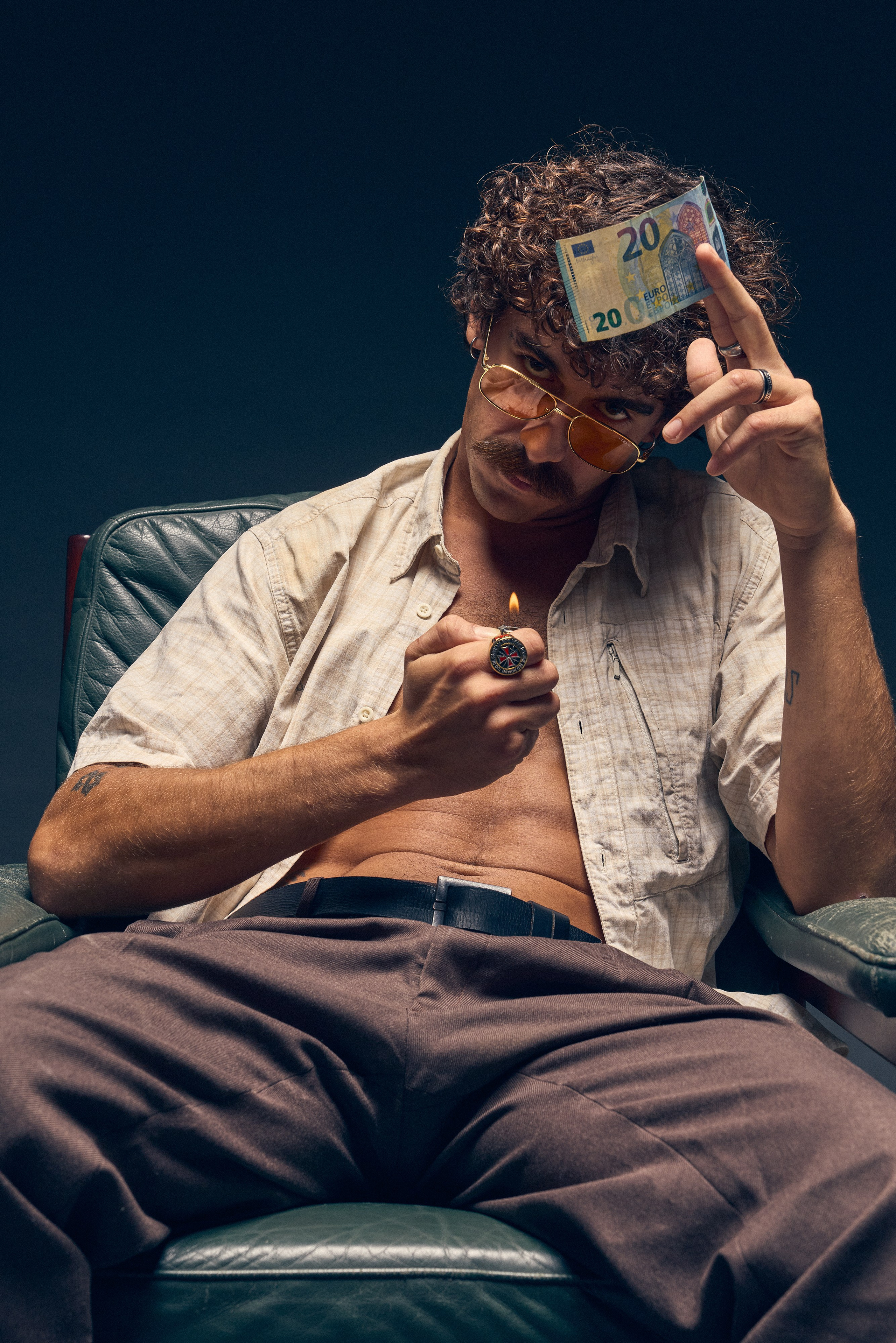 Man with curly hair and rings in vintage style photo