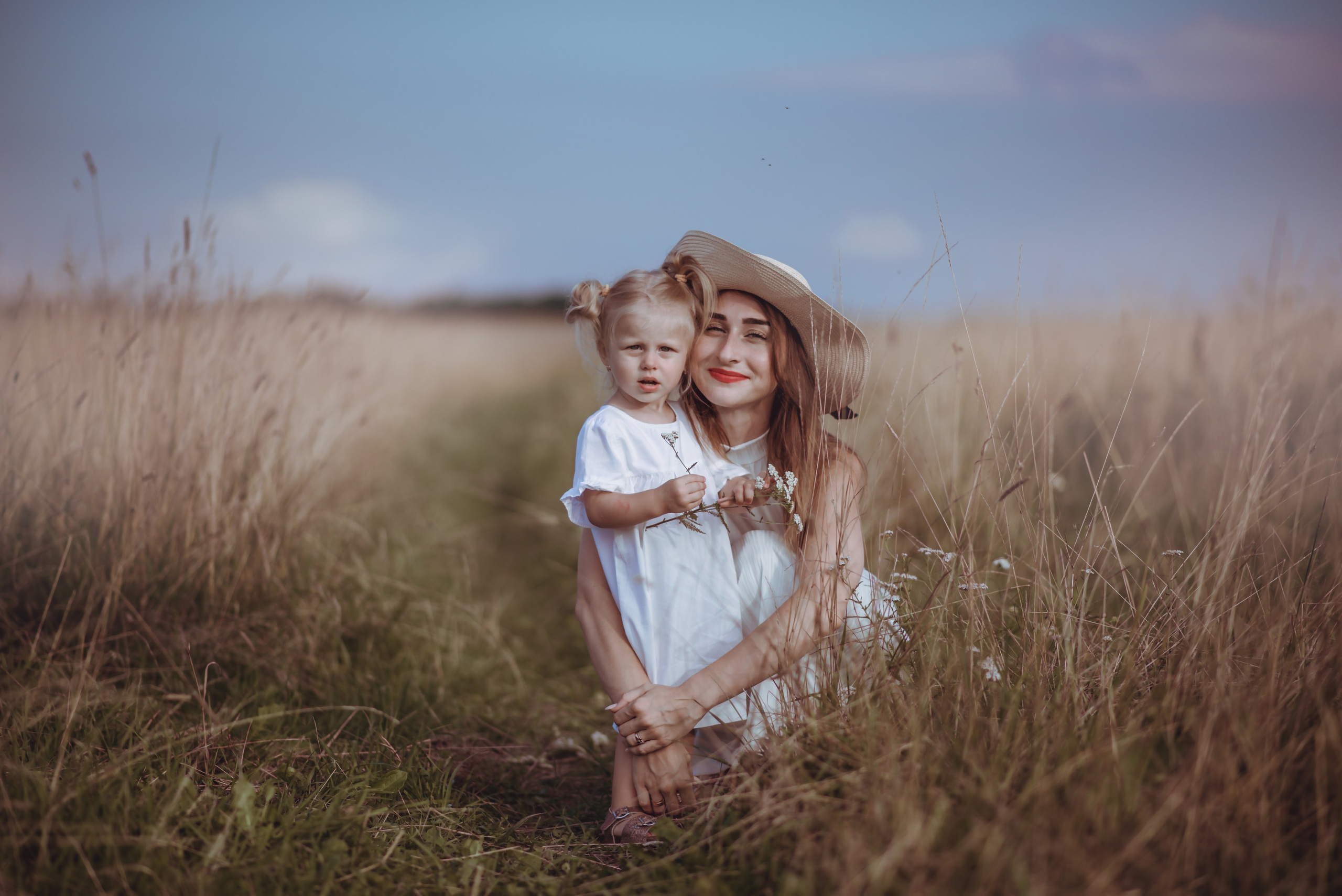 Mom sitting with her children in a meadow