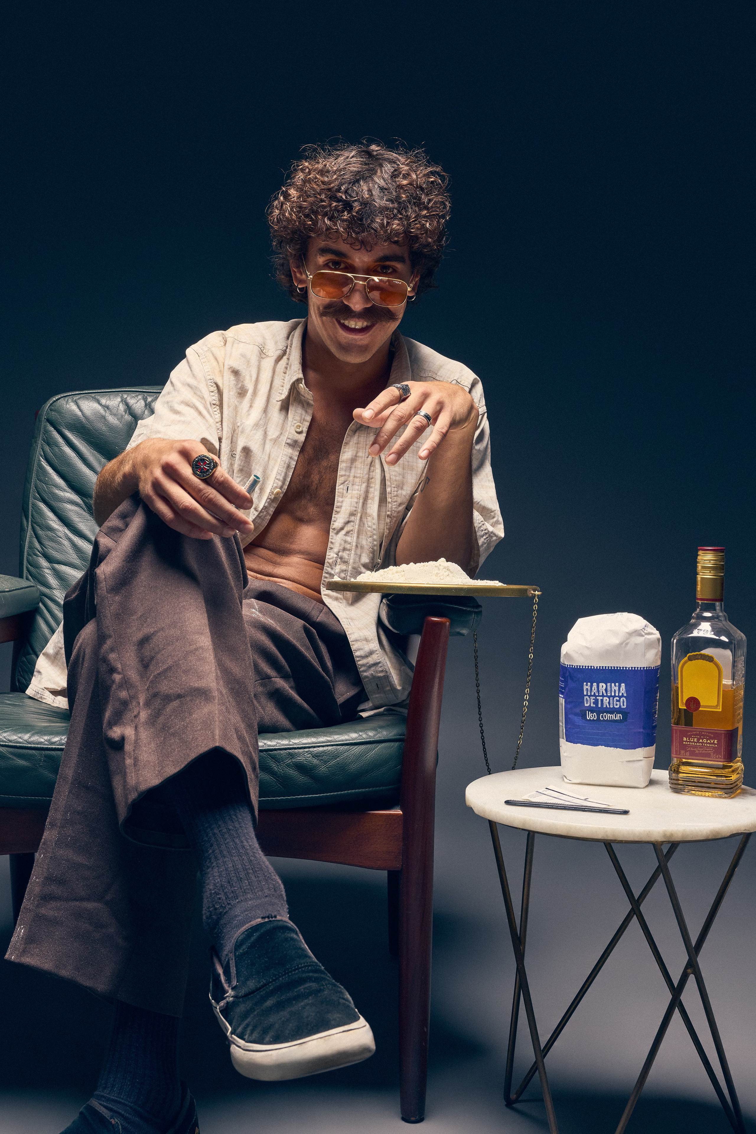 Man with curly hair and sunglasses in retro scene