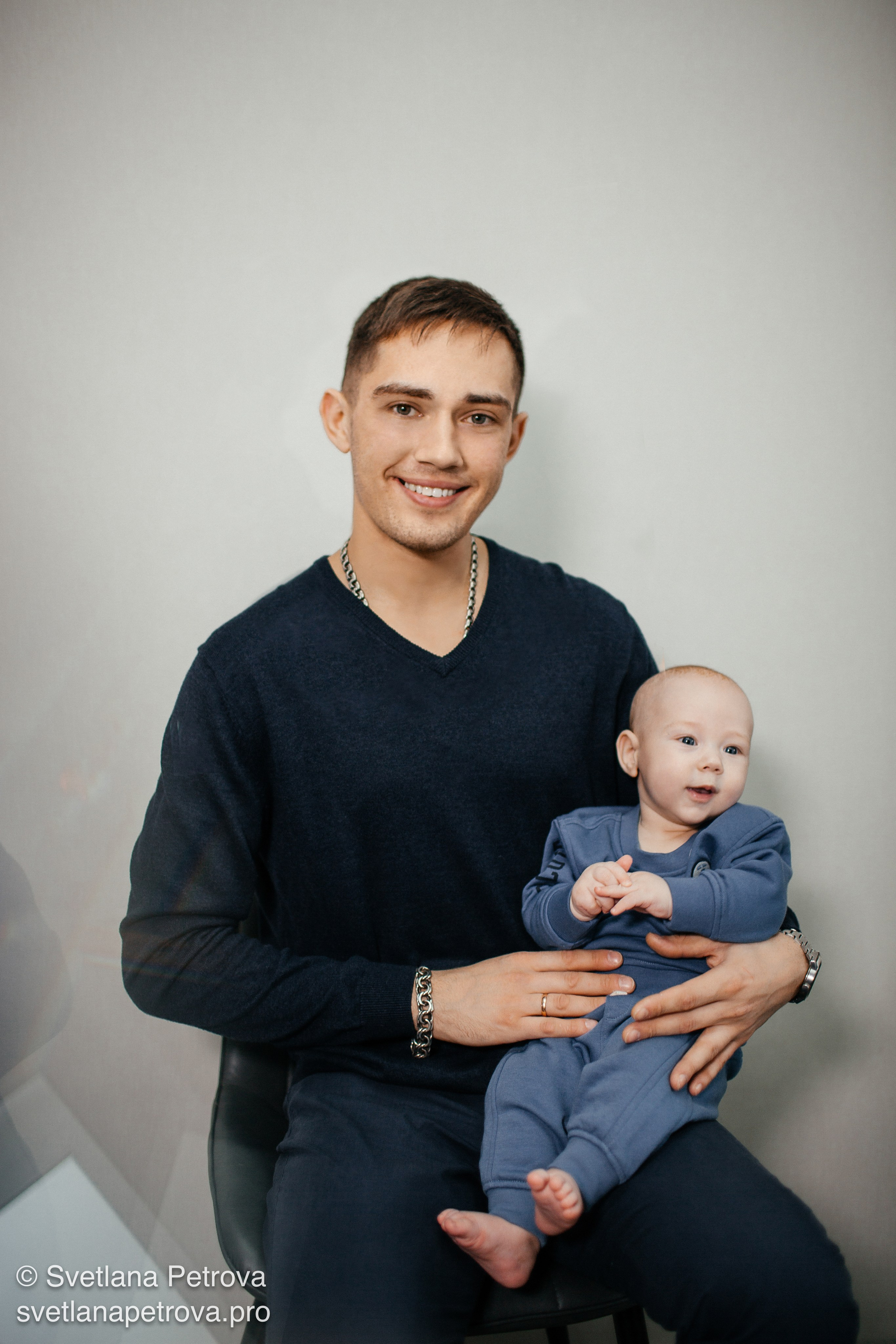 Папа держит малыша — тёплая фотосессия. Молодой отец и младенец — искренний момент. Отец с ребёнком на руках, уют. Кроха — семейная гармония в кадре. Малыш на руках у папы, светлая атмосфера. Семейная фотосессия: папа и его сын. Улыбка отца, любопытный взгляд малыша.
