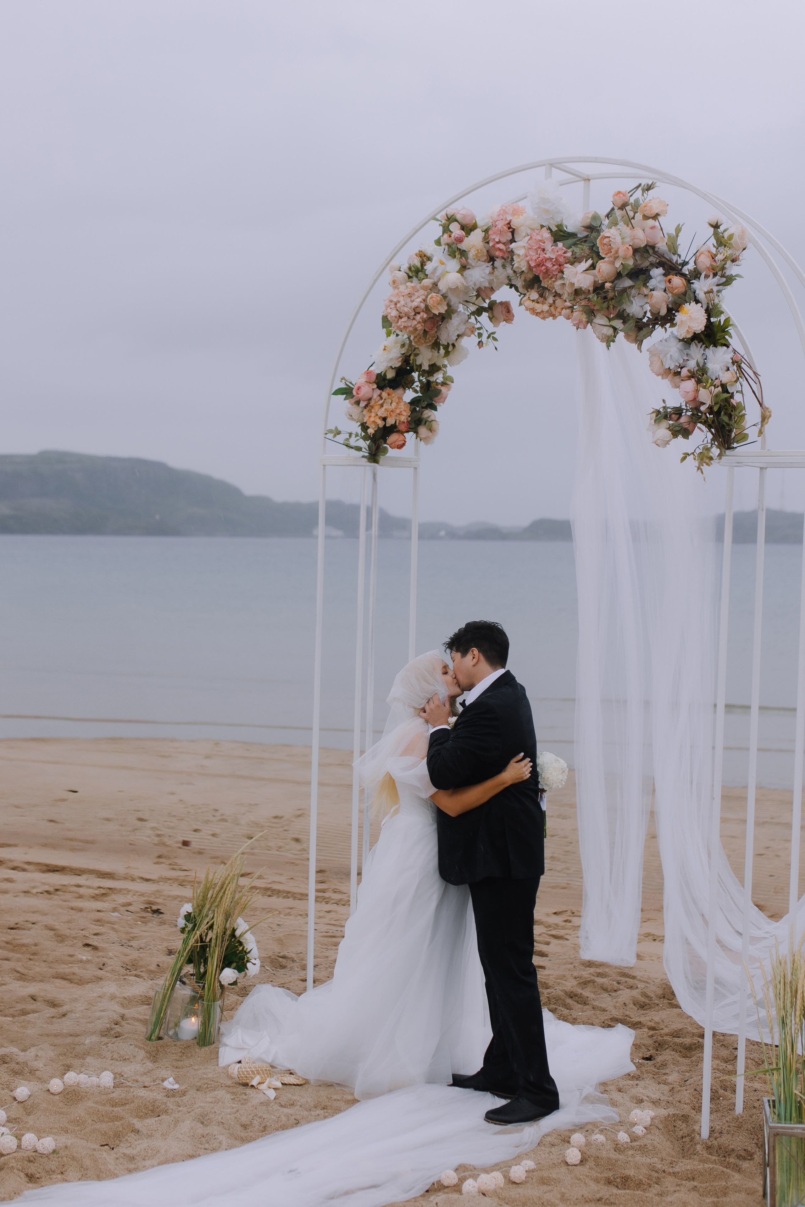 Молодожёны целуются на берегу Баренцева моря в Териберке.