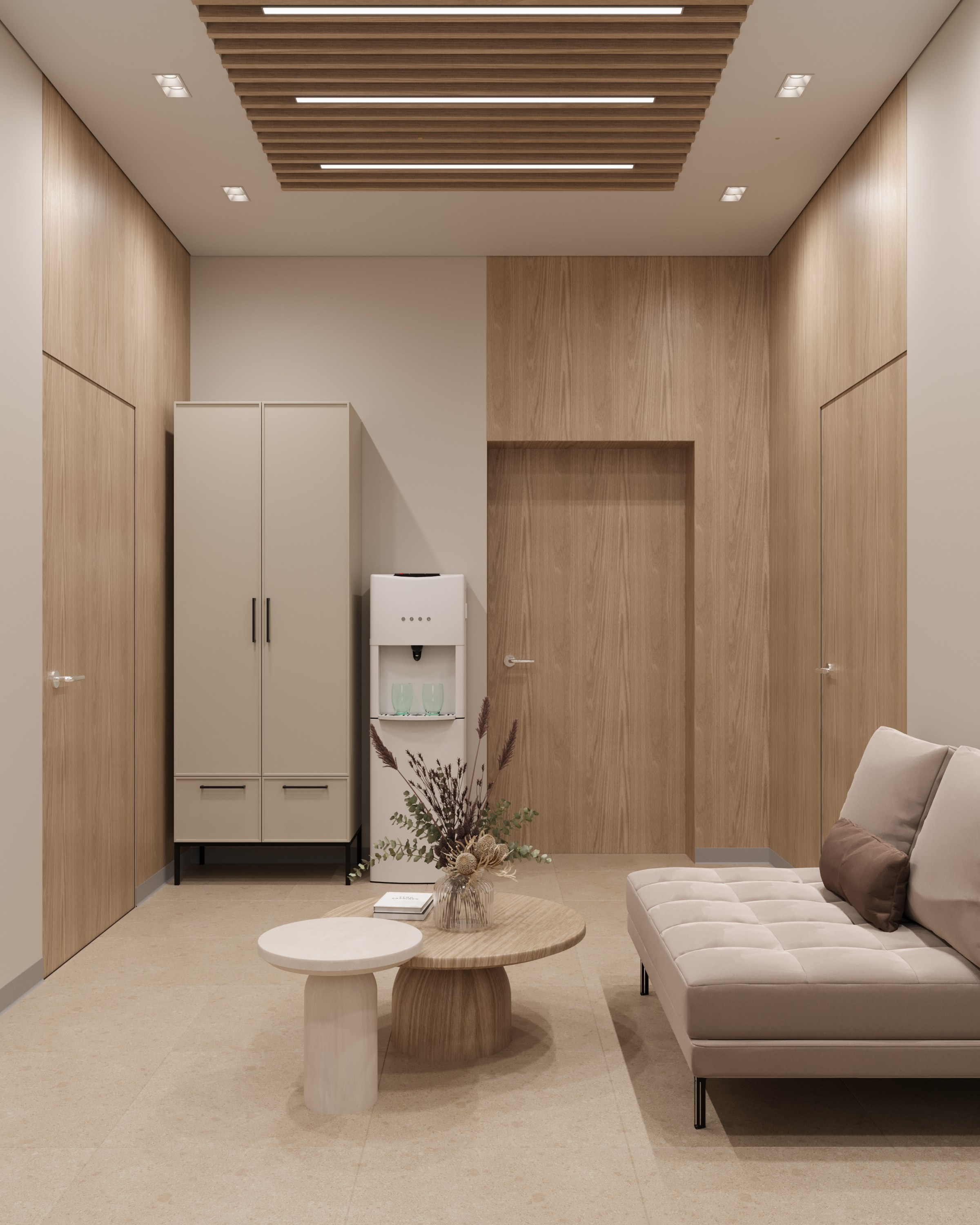 Интерьер приемной с бежевым диваном, двумя журнальными столиками и шкафом для хранения