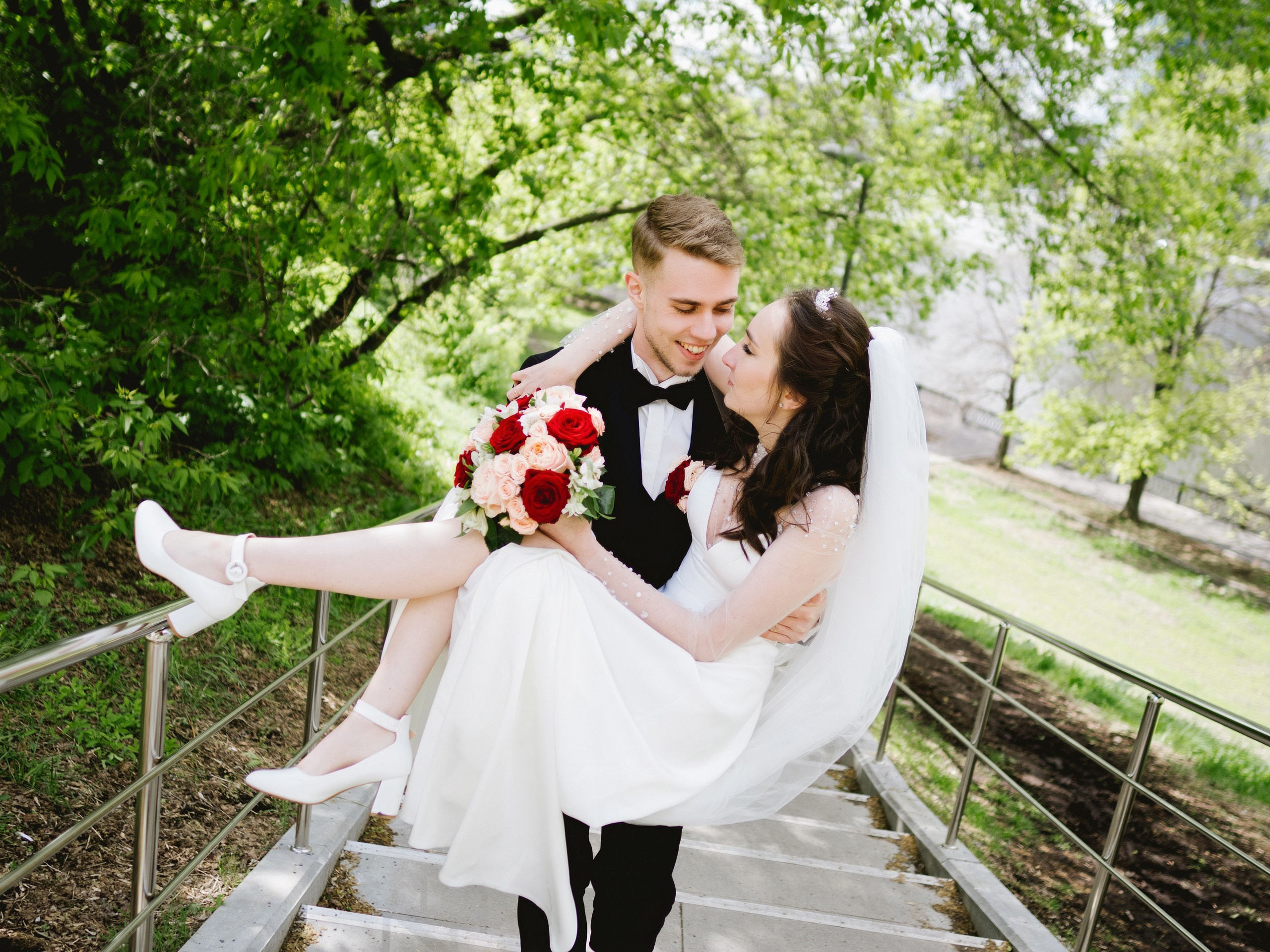 Жених несёт невесту на руках на свадебной фотосессии в Москве