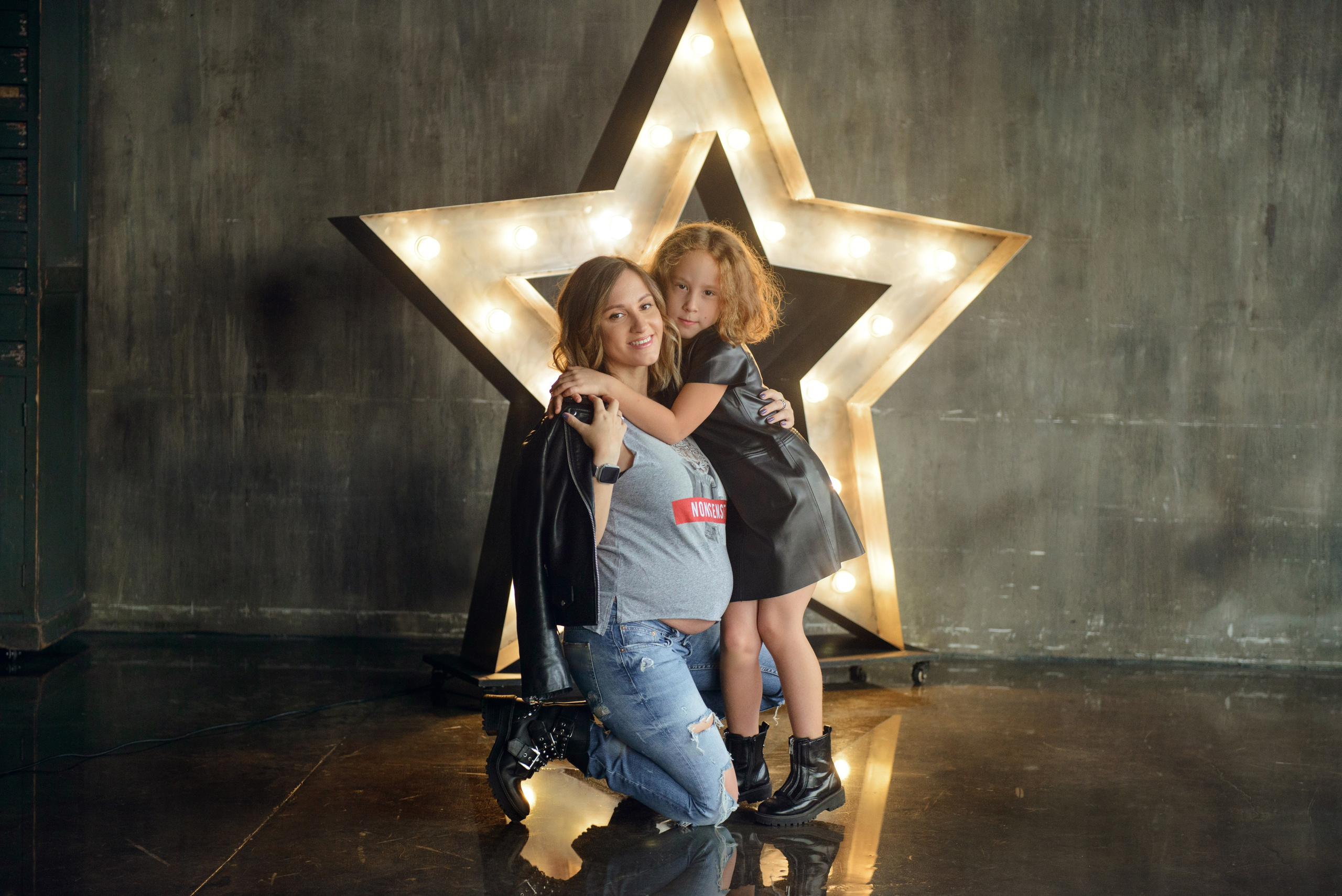Family photo shoot with a pregnant woman in a loft studio, rock and roll style