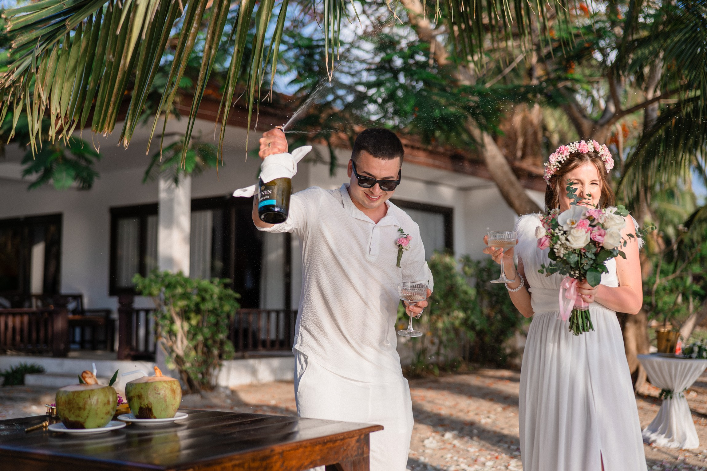 Bride and groom exchanging vows on a private sunset beach
