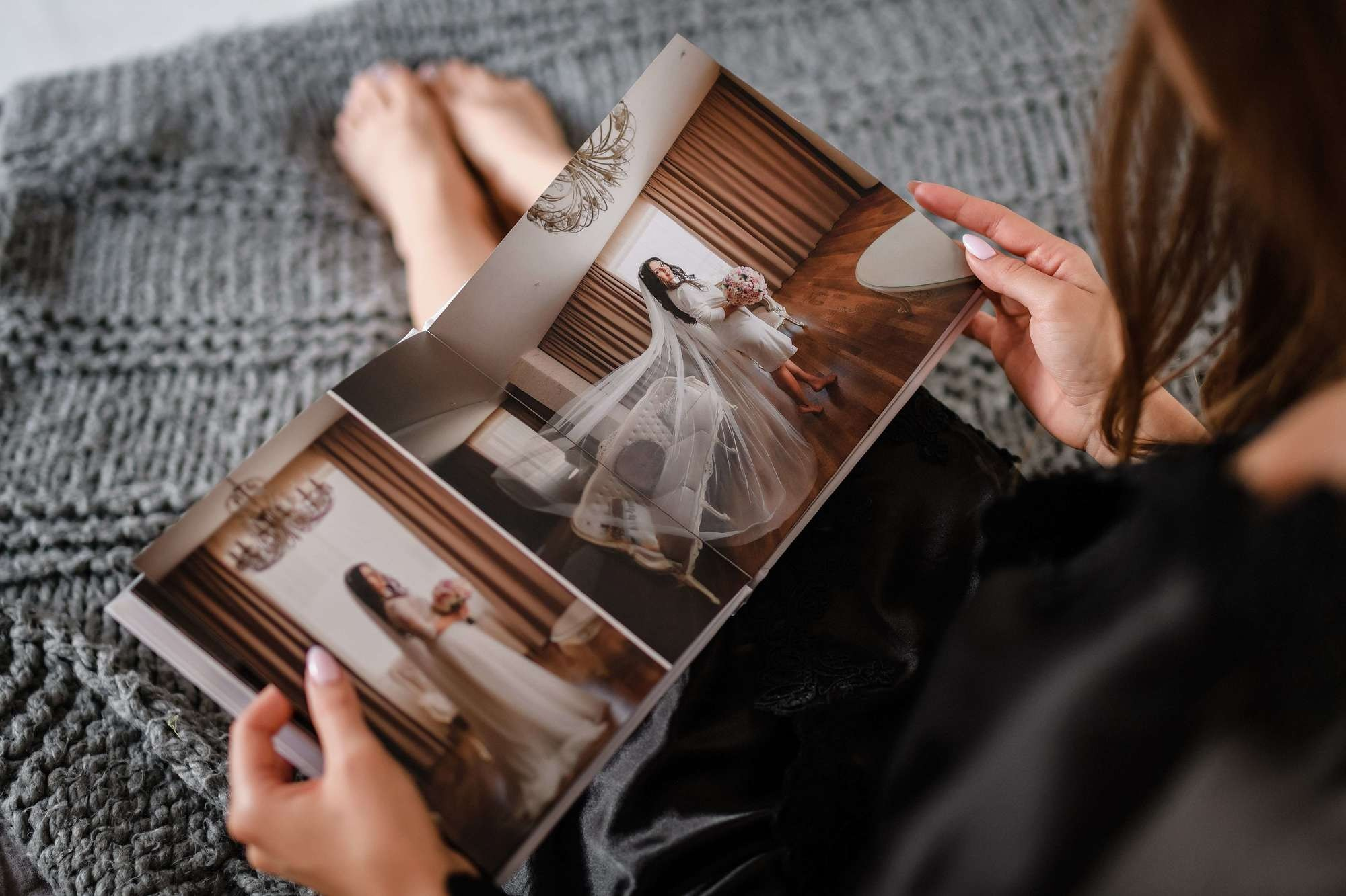 Невеста любуется свадебными фотографиями в книге 