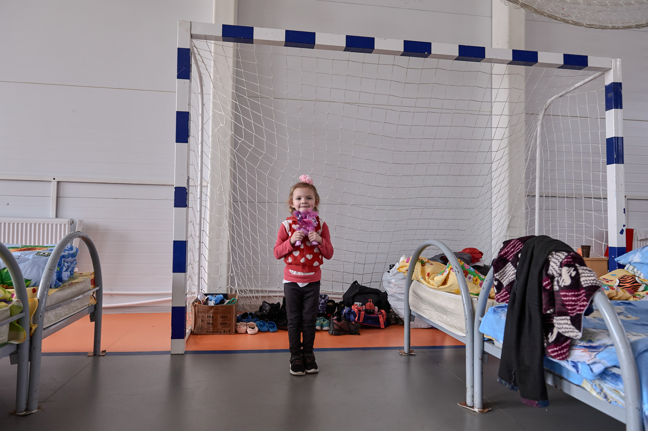 A girl, Viola Valiullina, originally from Uglegorsk, Donetsk region, evacuated to the Rostov region with her mother, Liliya, after intensified shelling, in a temporary refugee accommodation center set up in the sports hall of the rural cultural center in Lenin Hamlet, Rostov region, February 22, 2022.