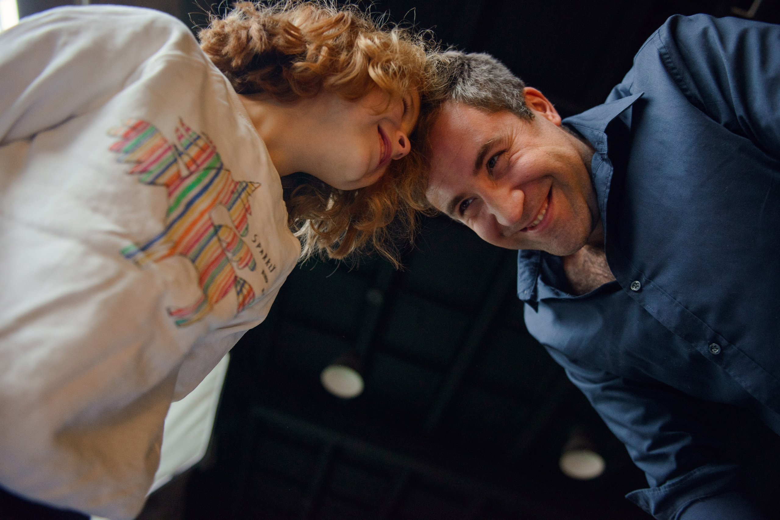 dad and daughter in a dark photo studio