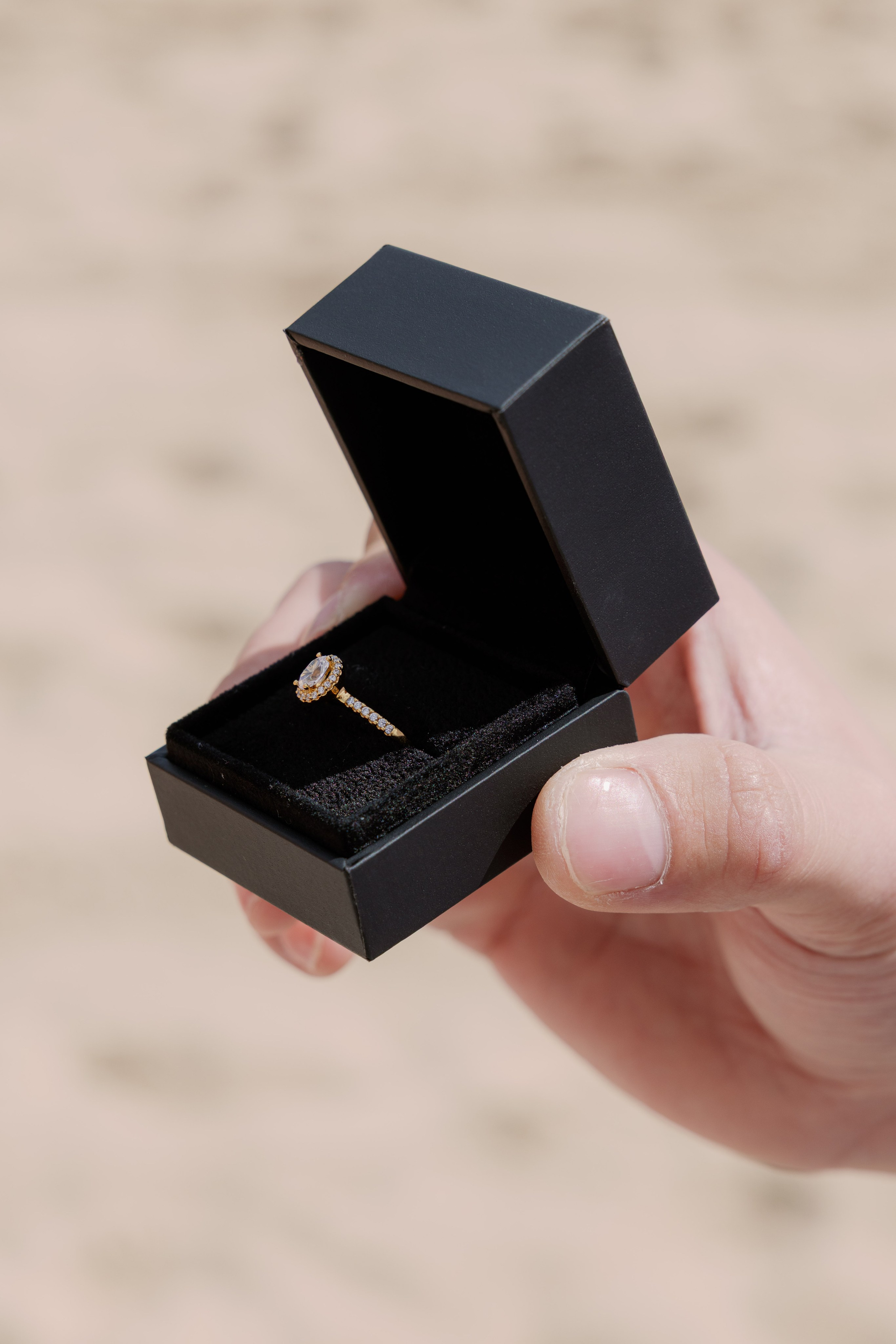 Romantic marriage proposal at sunset in Barcelona overlooking the sea