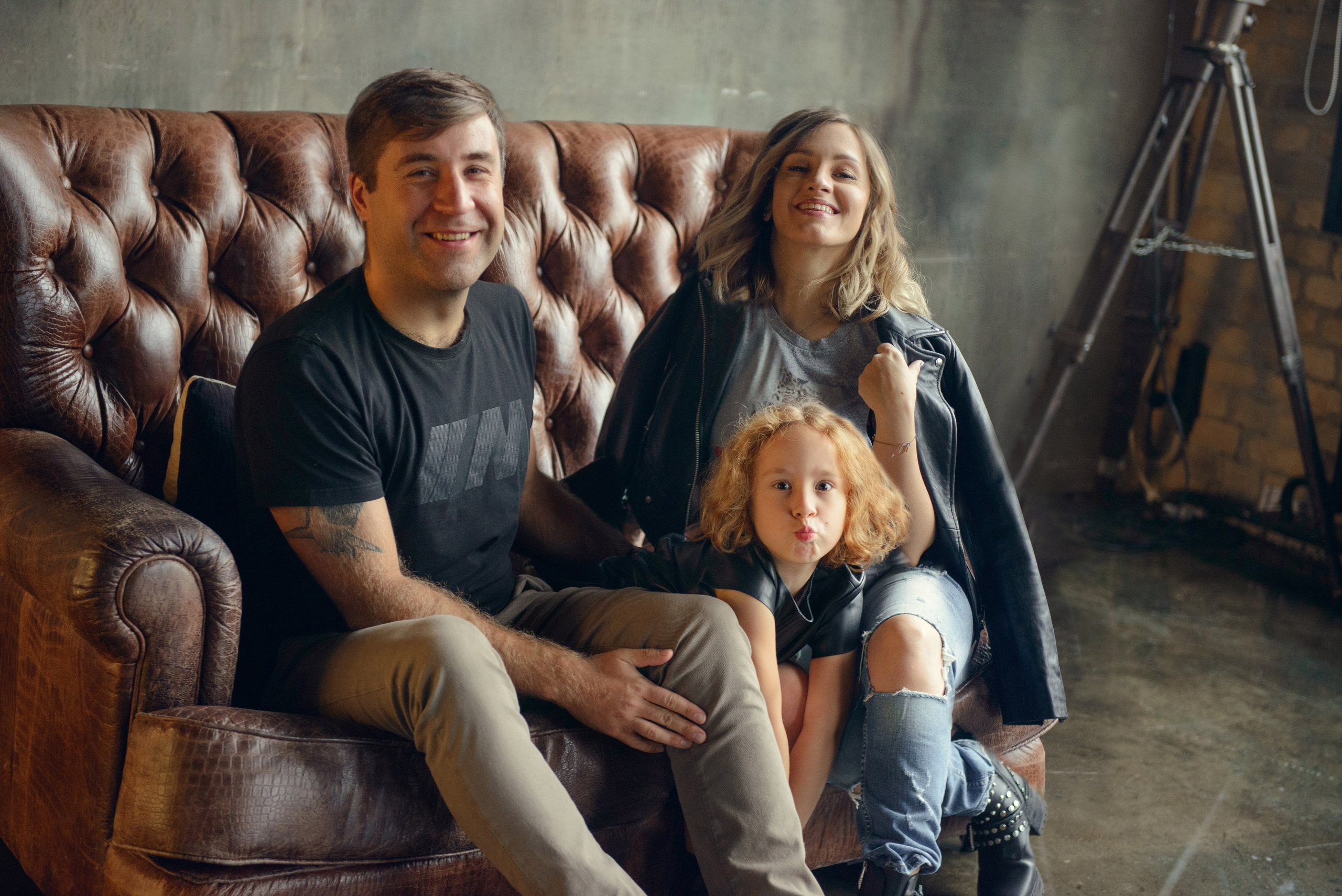 Family photo shoot with a pregnant woman in a loft studio, rock and roll style