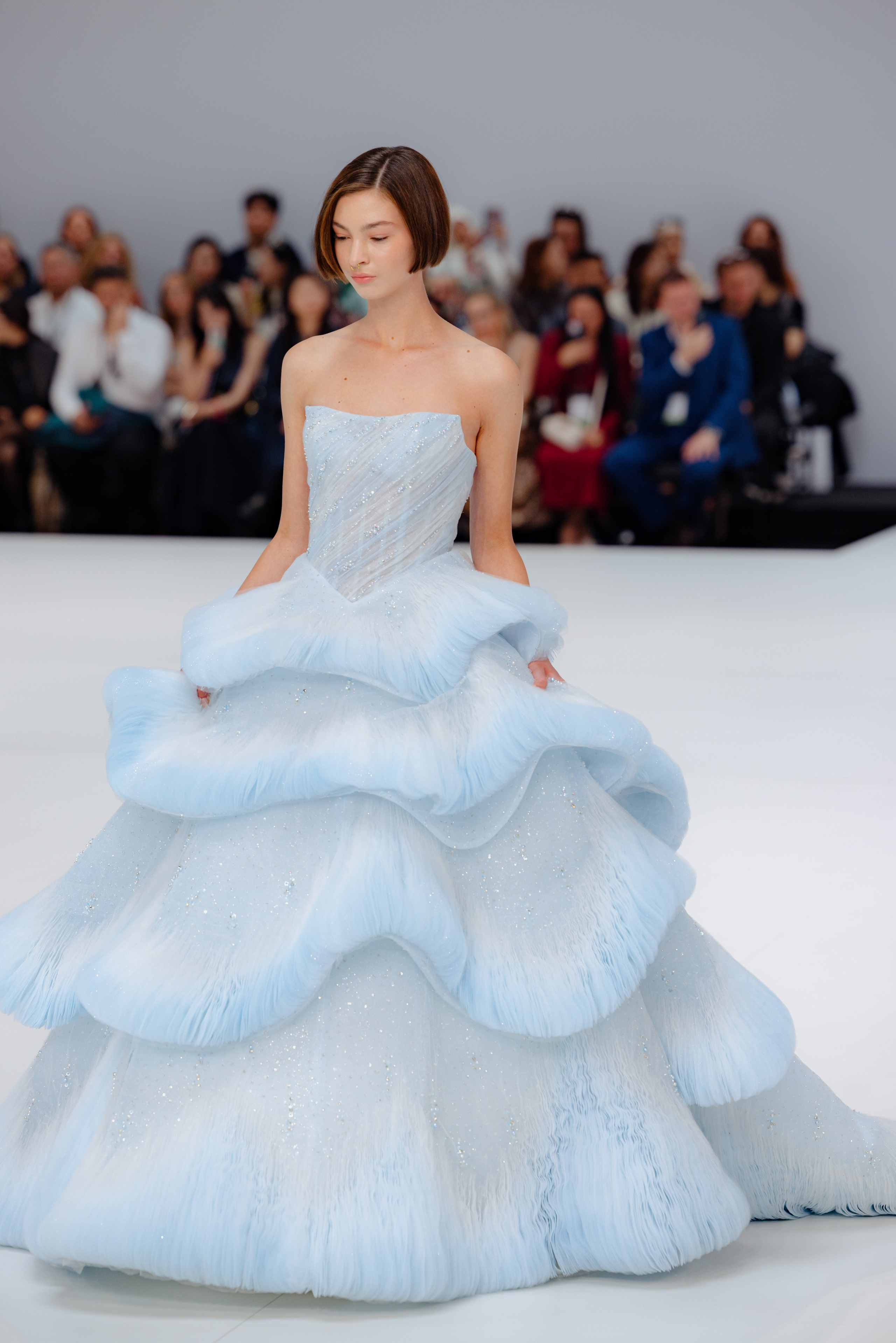 Behind-the-scenes moment with bridal gown adjustments before the show