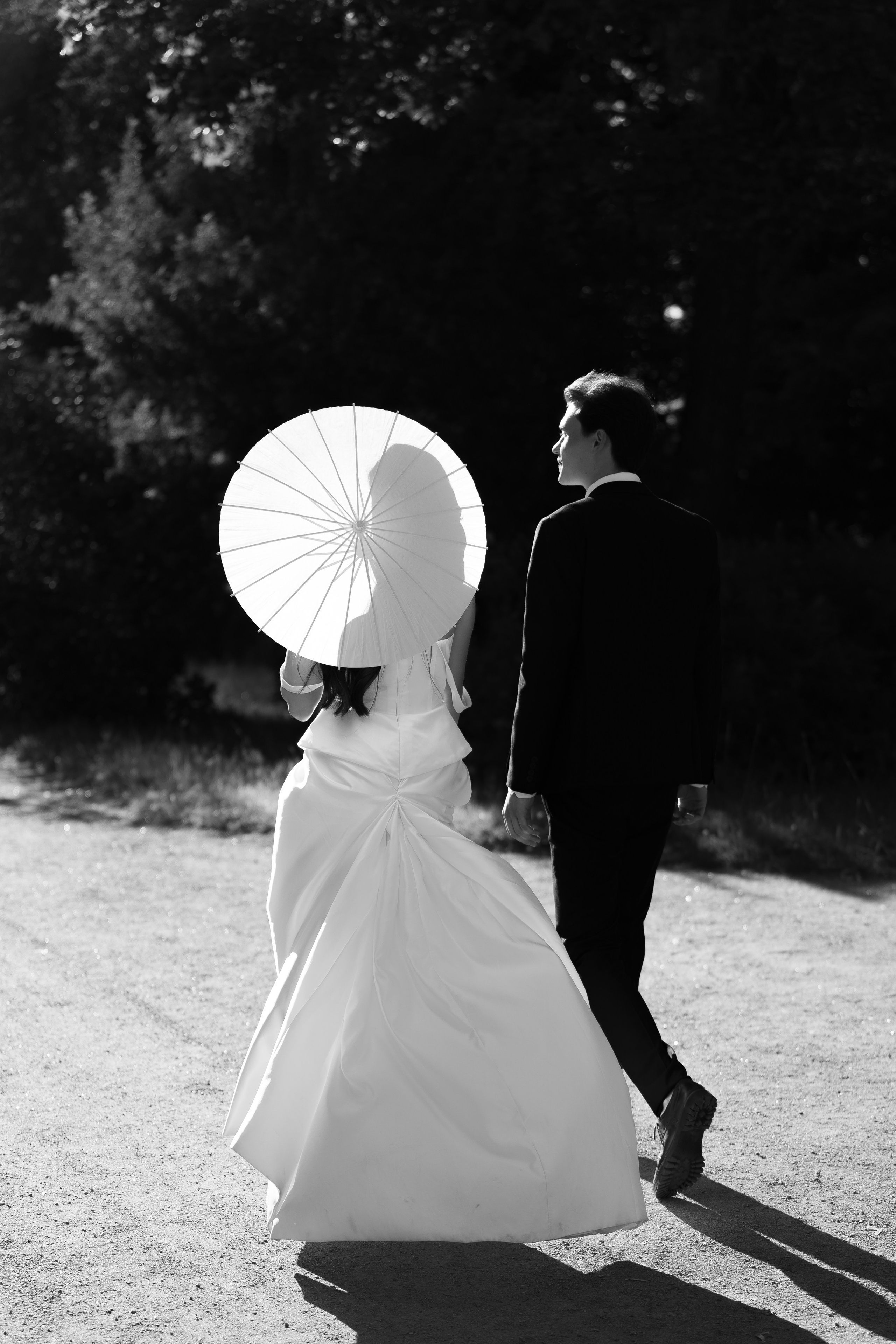 Чёрно-белый кадр, жених и невеста с зонтом в парке Ораниенбаум